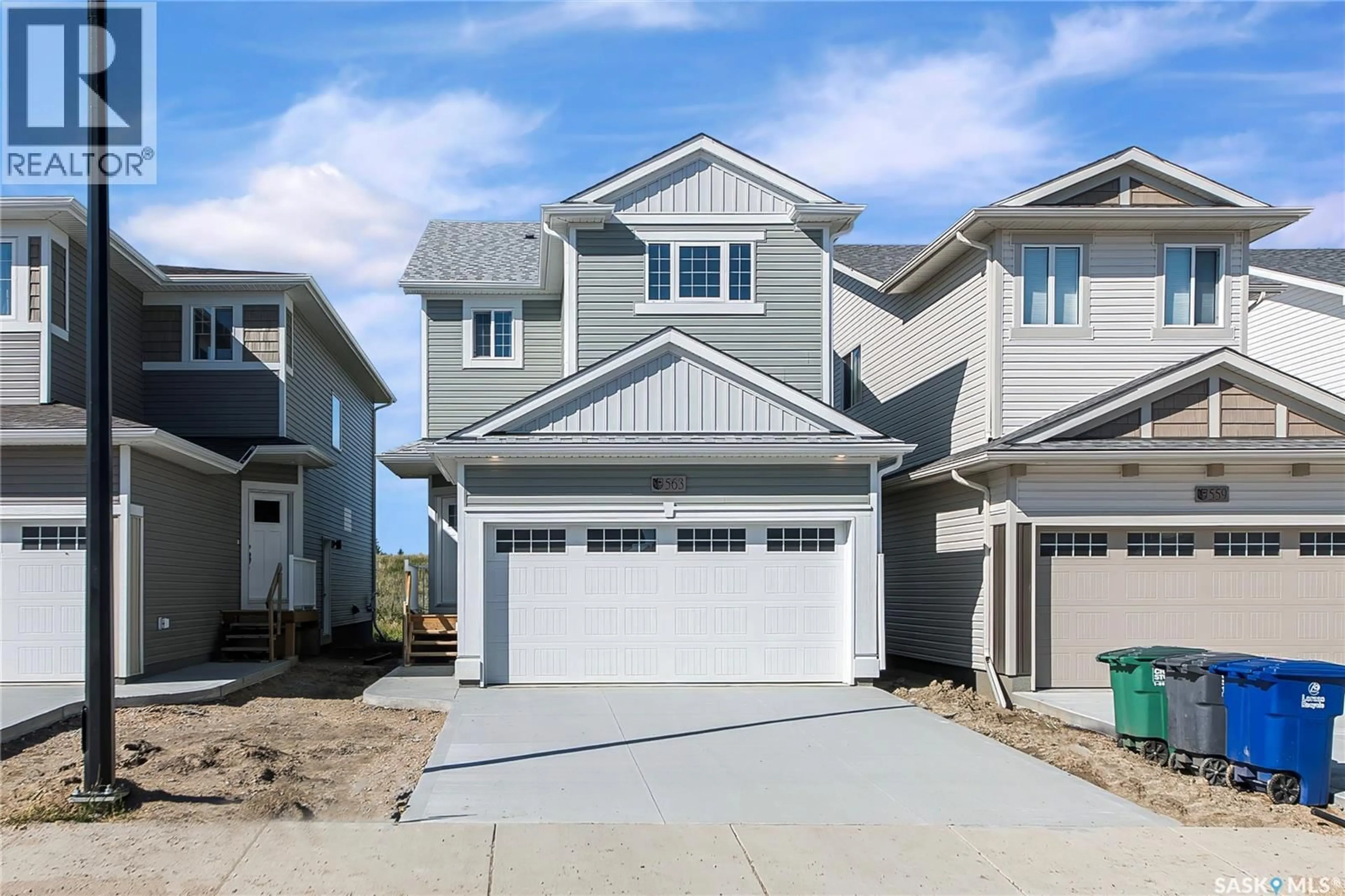Home with vinyl exterior material, street for 563 TRAEGER MANOR, Saskatoon Saskatchewan S7V1Z8