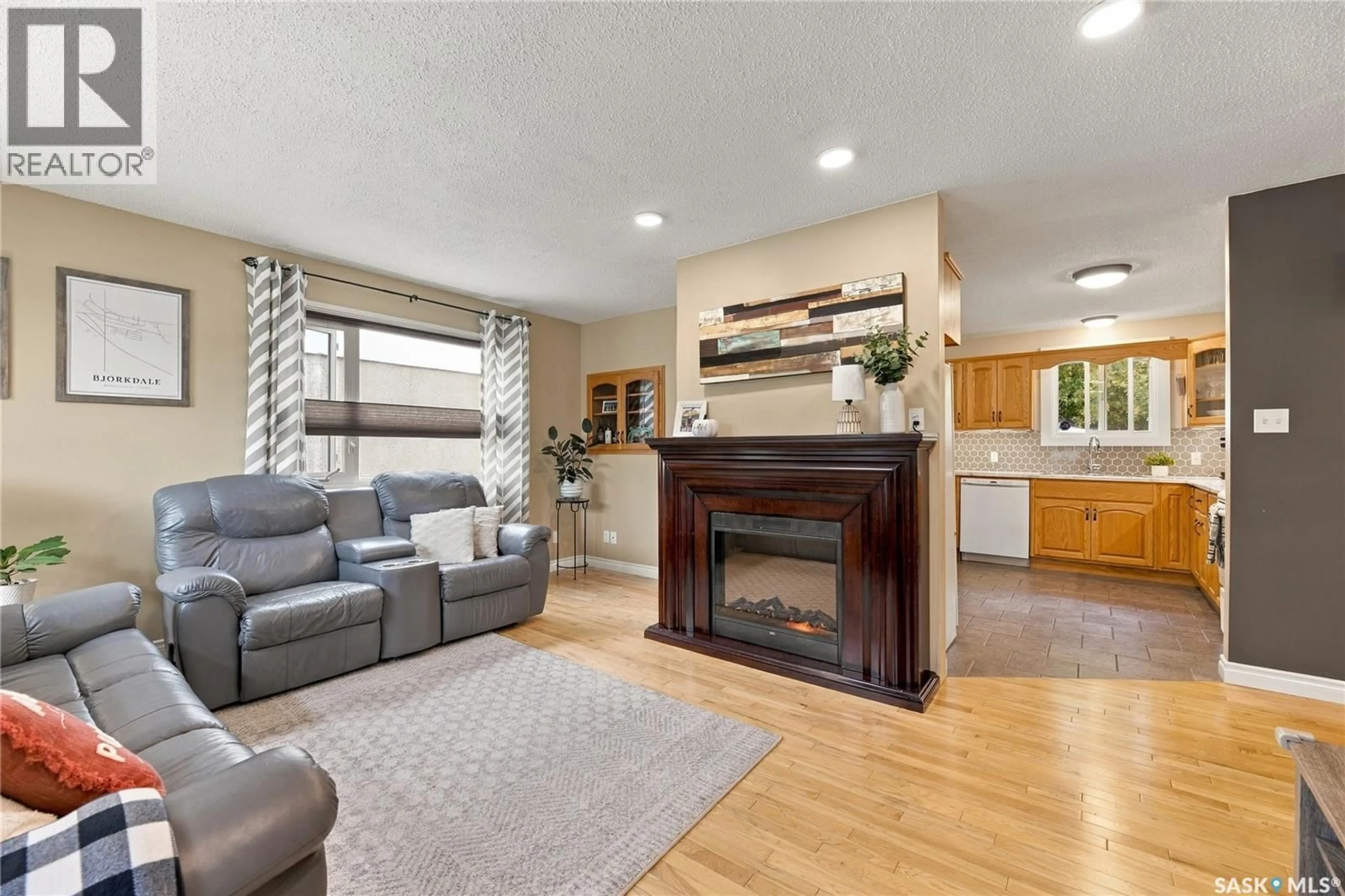 Living room with furniture, wood/laminate floor for 341 BOYCHUK DRIVE, Saskatoon Saskatchewan S7H4J8
