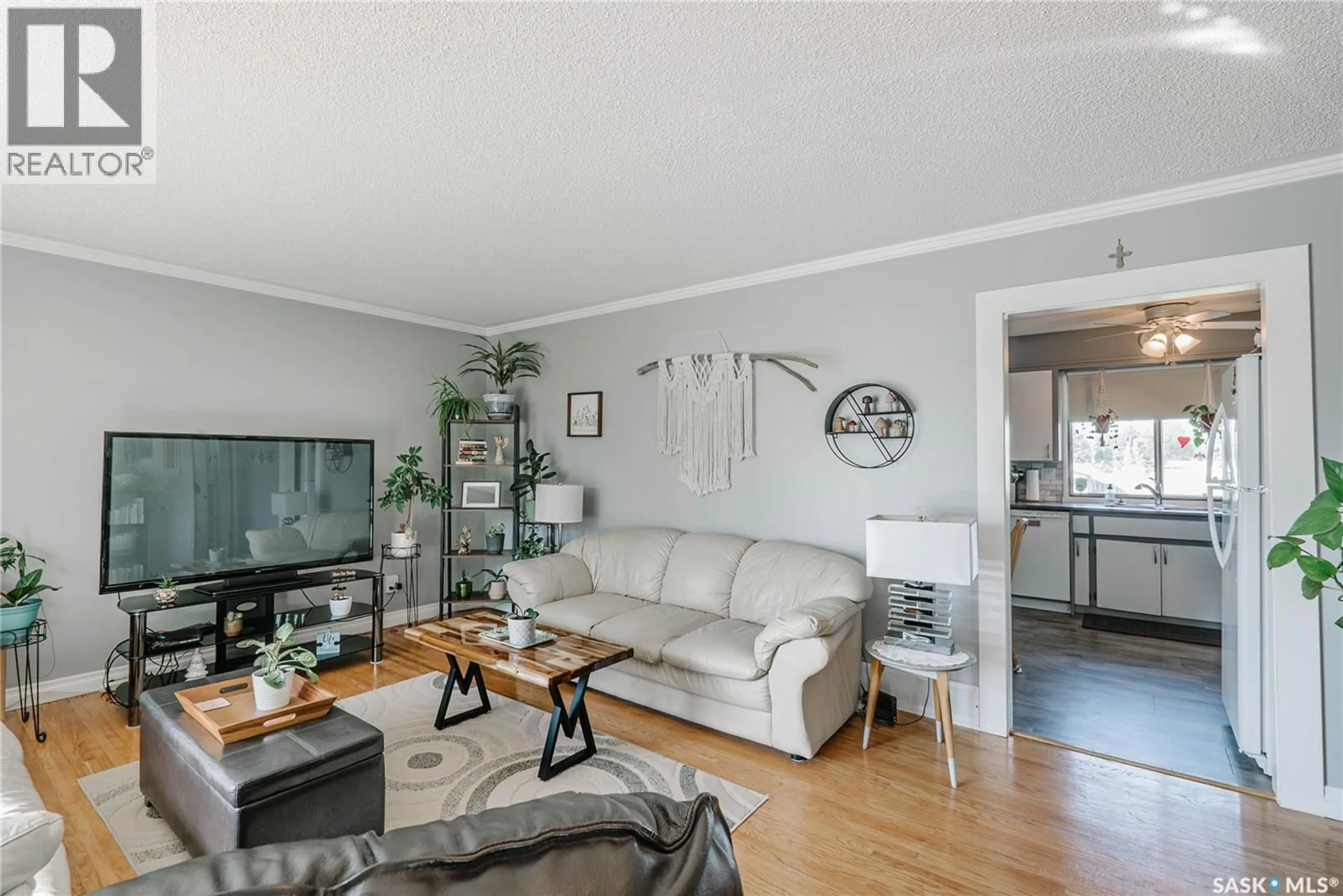 Living room with furniture, wood/laminate floor for 850 EAST CENTRE, Saskatoon Saskatchewan S7J2Z7