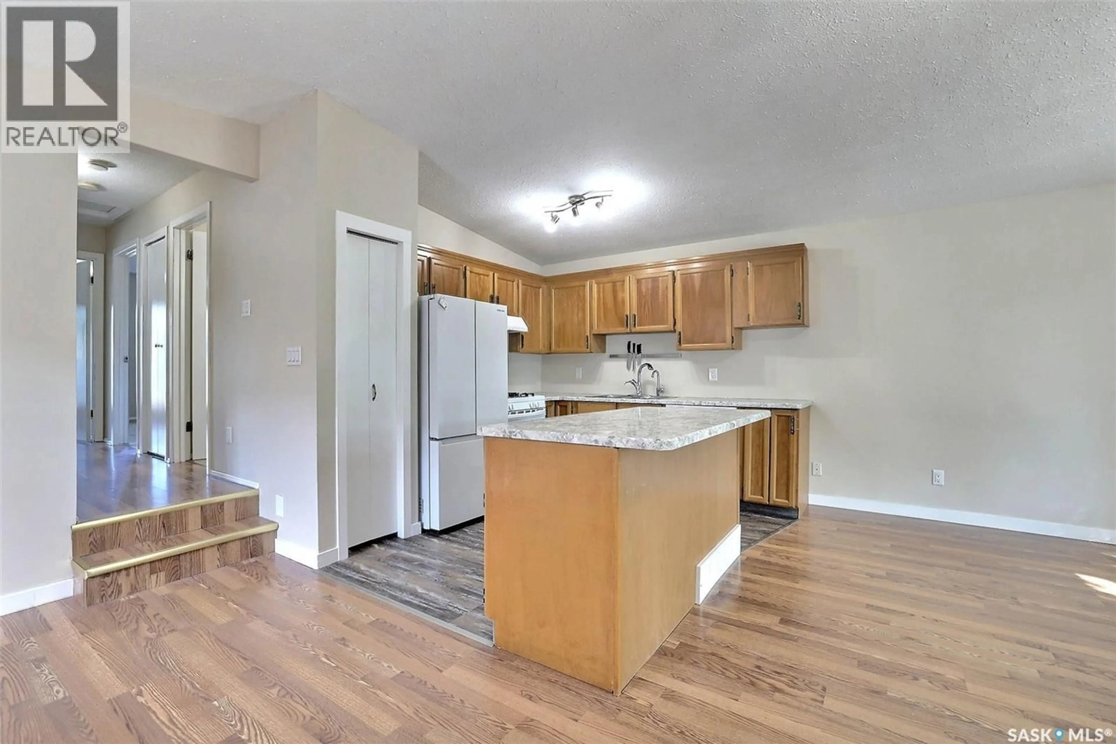 Open concept kitchen, wood/laminate floor for 7126 DALGLIESH DRIVE, Regina Saskatchewan S4X2M6