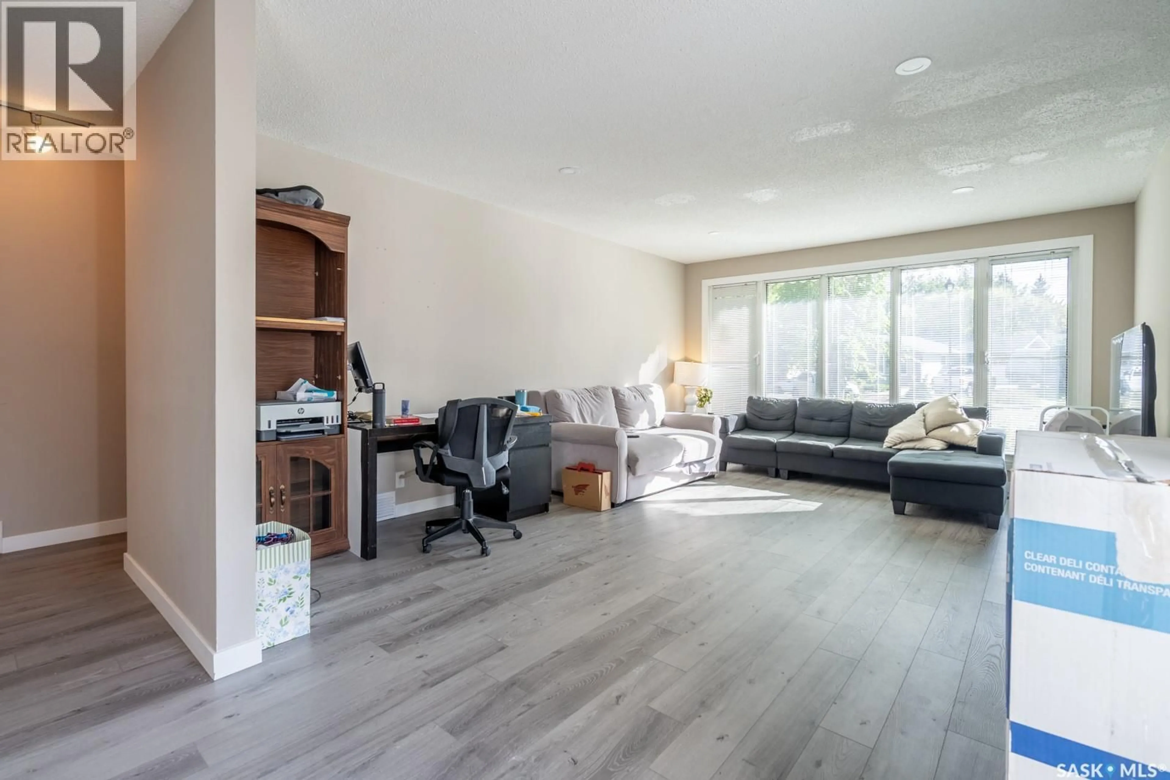 Living room with furniture, wood/laminate floor for 11 BRIARWOOD PLACE, Regina Saskatchewan S4S5M8