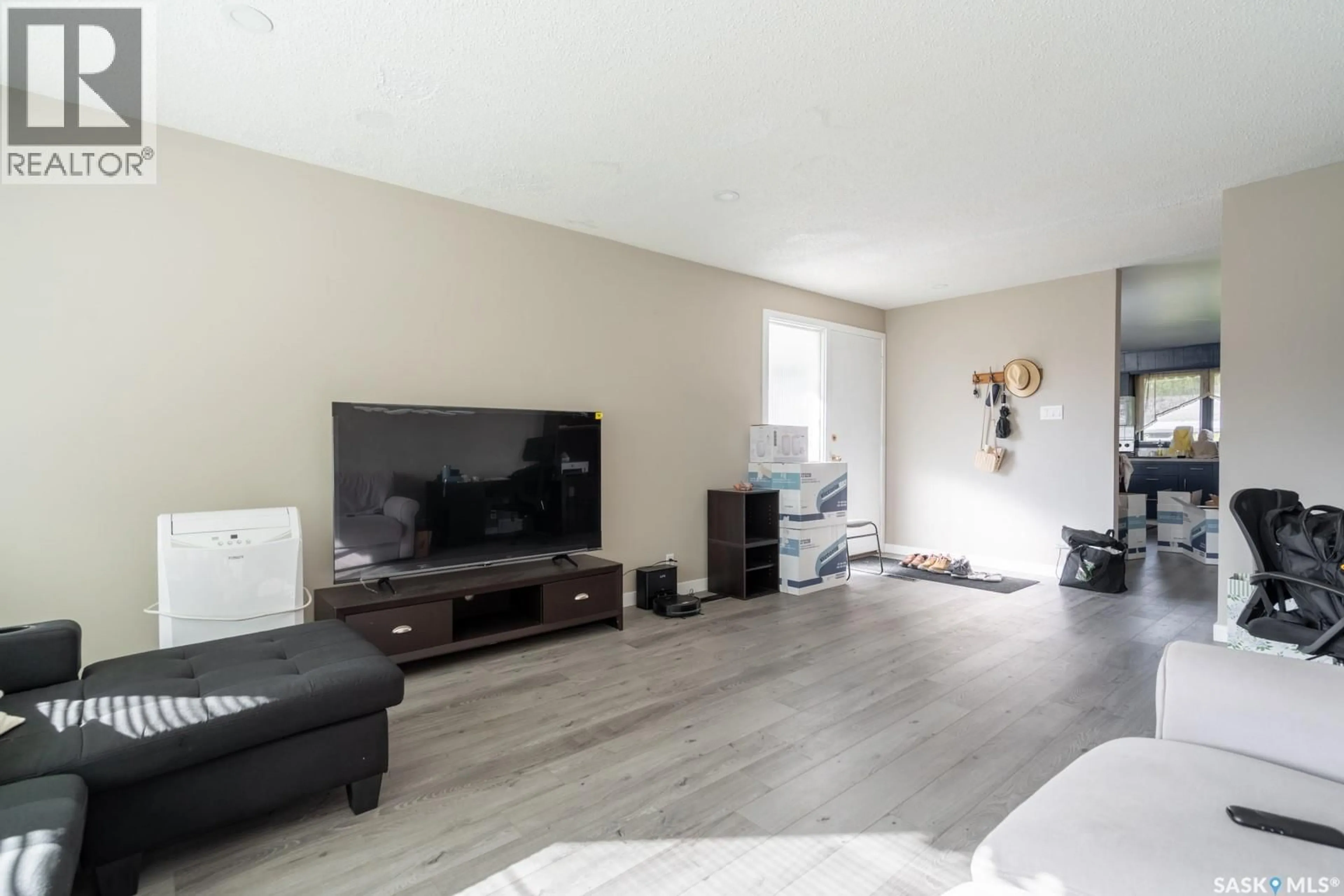 Living room with furniture, wood/laminate floor for 11 BRIARWOOD PLACE, Regina Saskatchewan S4S5M8