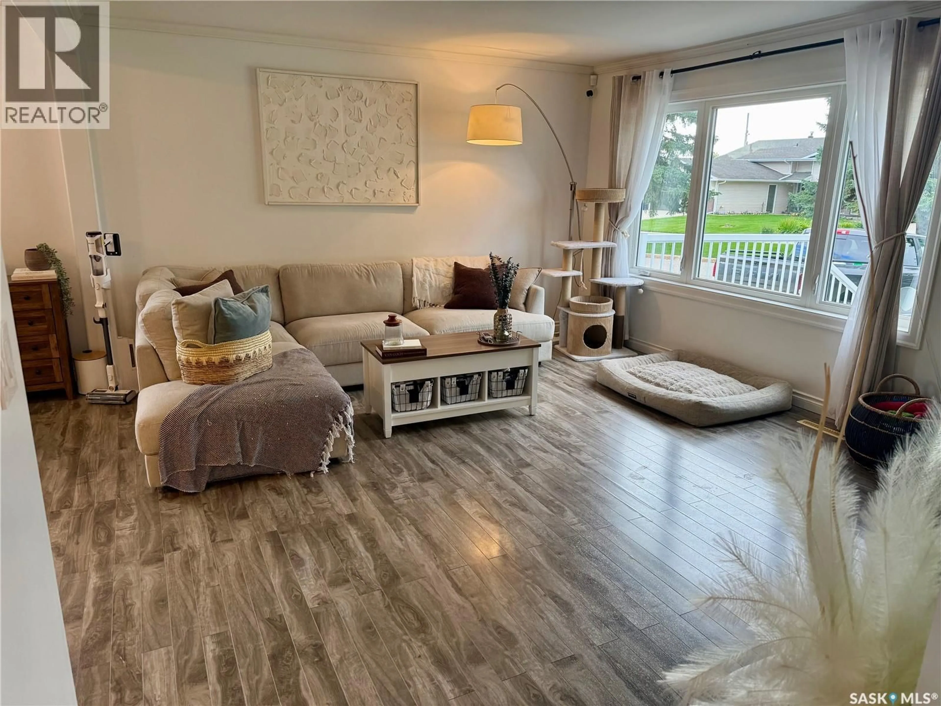 Living room with furniture, wood/laminate floor for E - 105 5TH STREET, Nipawin Saskatchewan S0E1E0
