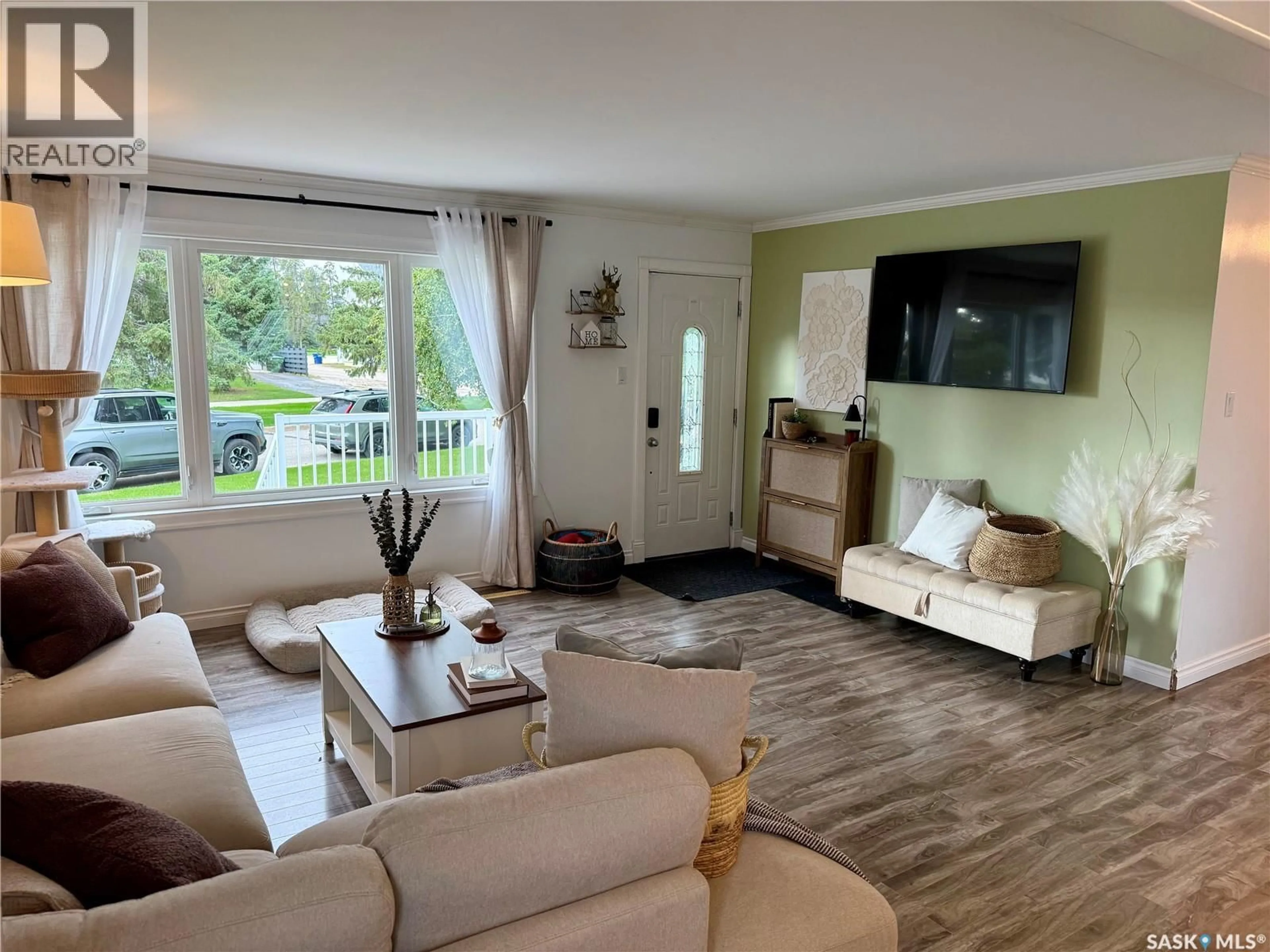 Living room with furniture, wood/laminate floor for E - 105 5TH STREET, Nipawin Saskatchewan S0E1E0