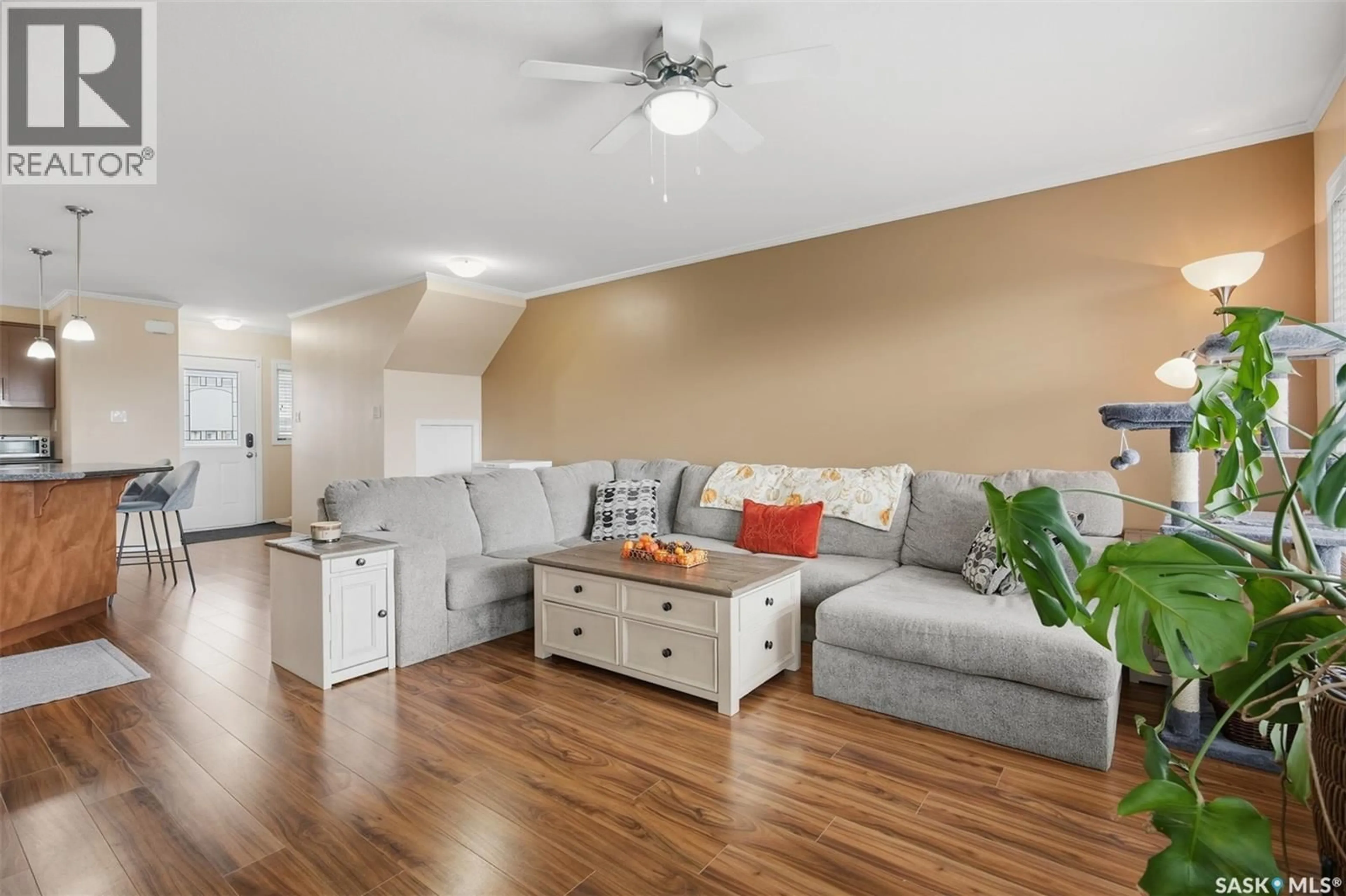 Living room with furniture, wood/laminate floor for 115 - 310 DALGLEISH LINK, Saskatoon Saskatchewan S7W0N5
