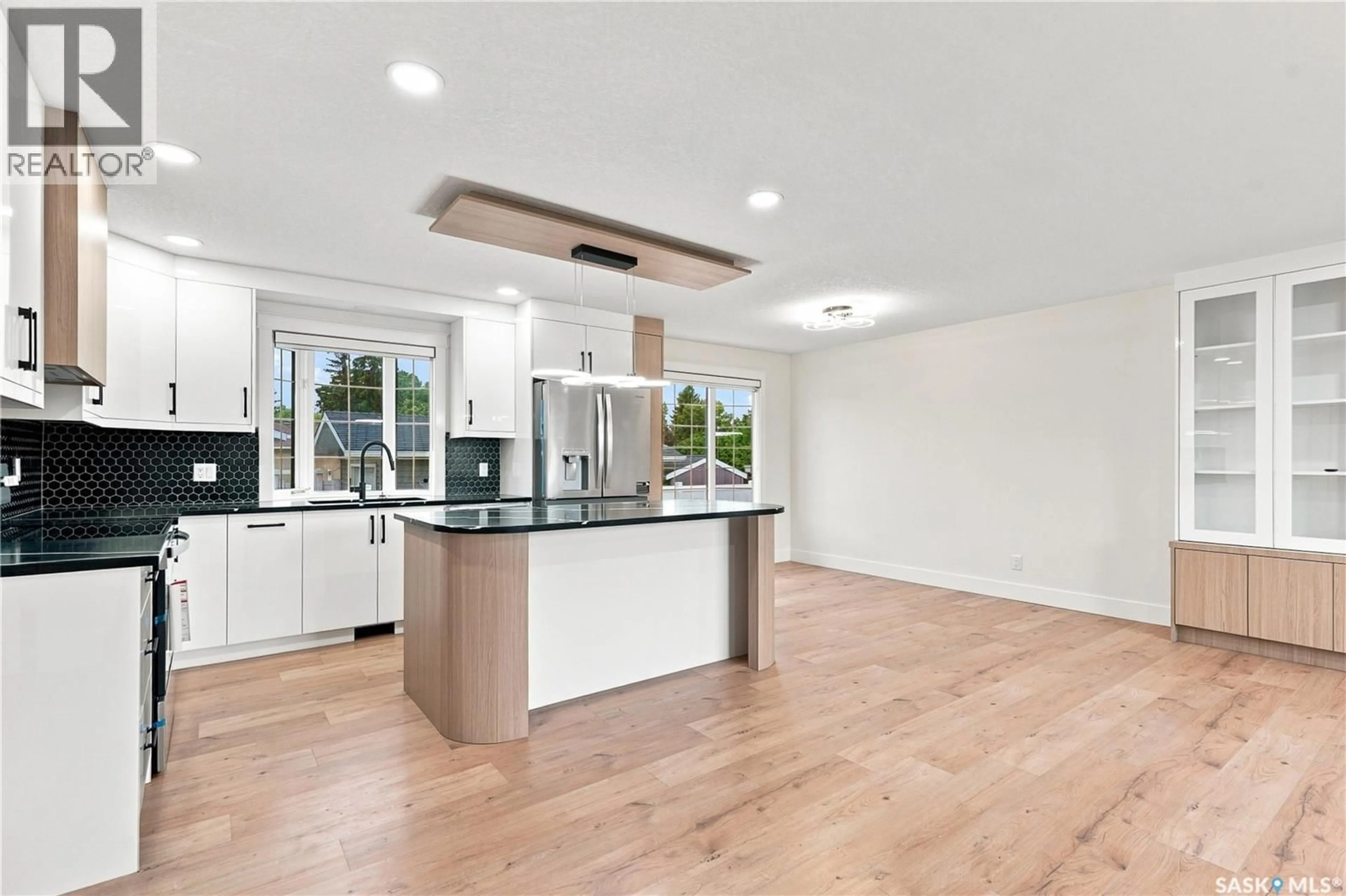 Open concept kitchen, wood/laminate floor for 702 MCKERCHER DRIVE, Saskatoon Saskatchewan S7H3W7