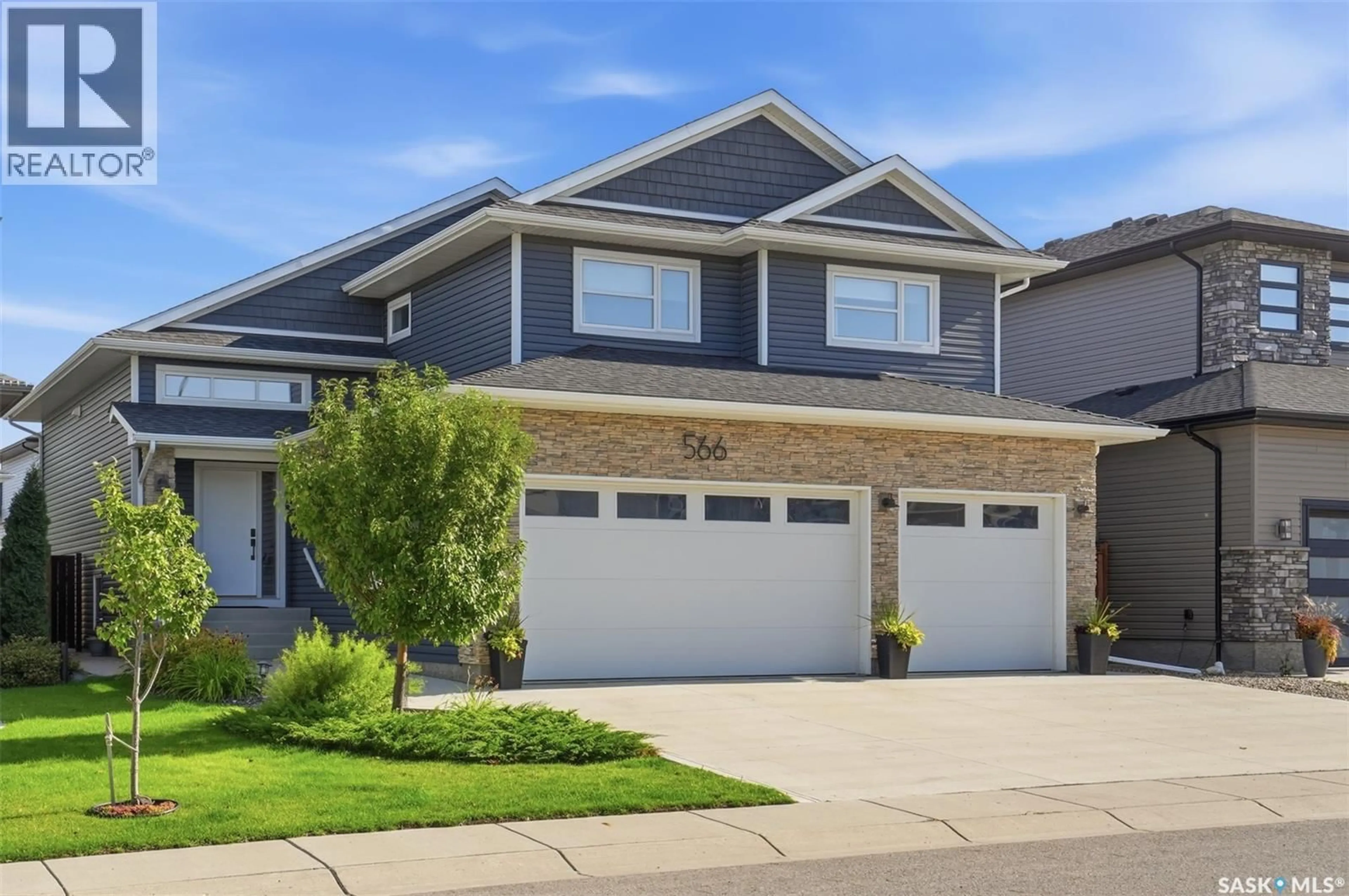 Home with vinyl exterior material, street for 566 BOLSTAD TURN, Saskatoon Saskatchewan S7W0X9