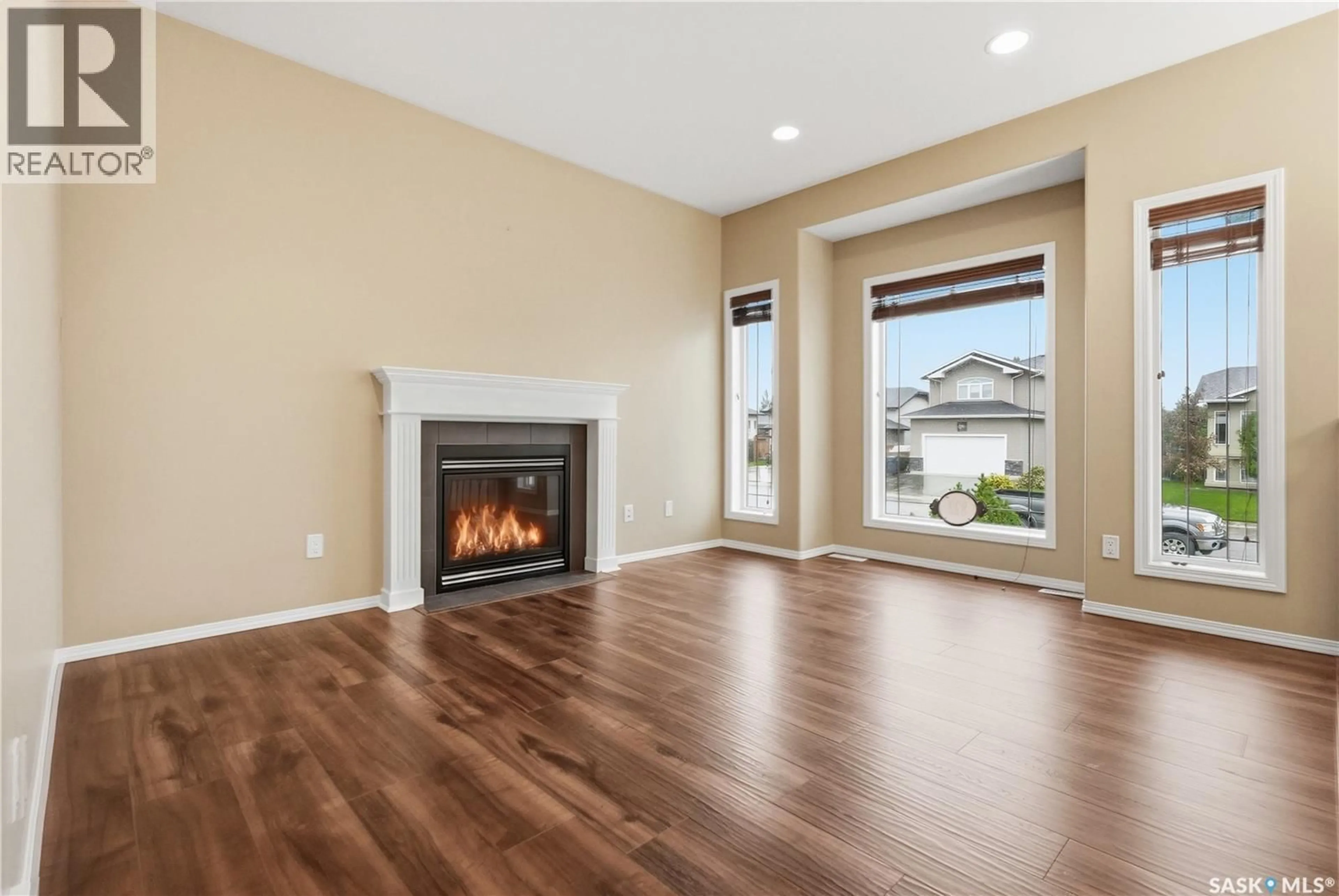 Living room with furniture, wood/laminate floor for 822 ROCK HILL LANE, Martensville Saskatchewan S0K0A2
