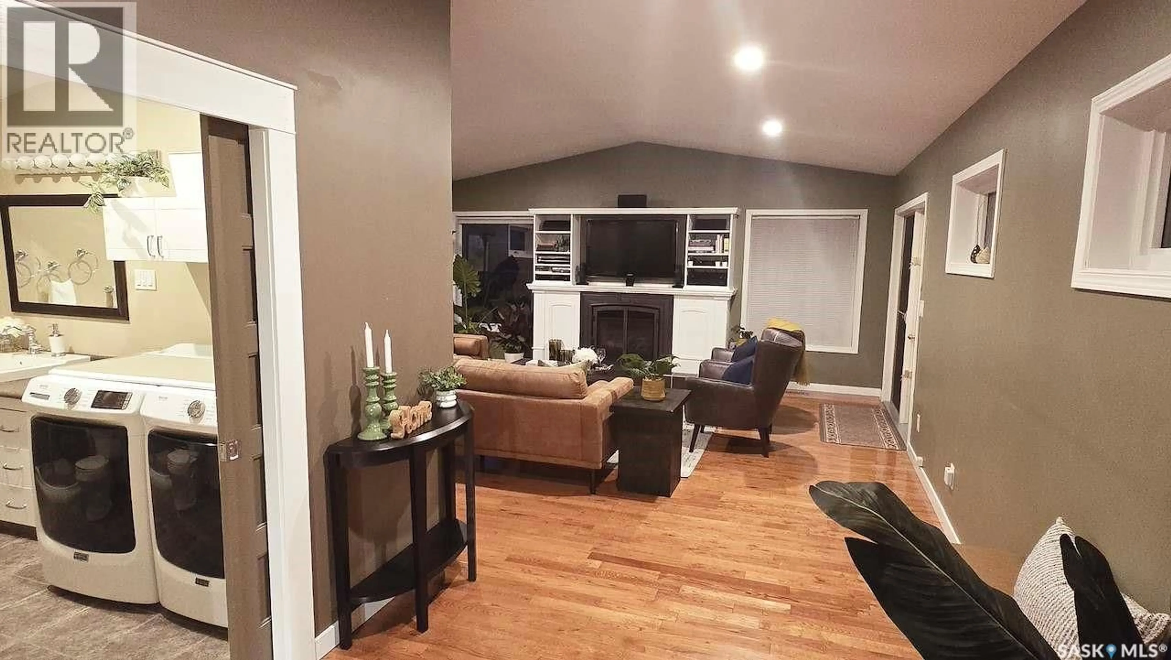Living room with furniture, wood/laminate floor for 2133 MCKINNON AVENUE, Saskatoon Saskatchewan S7J1N3