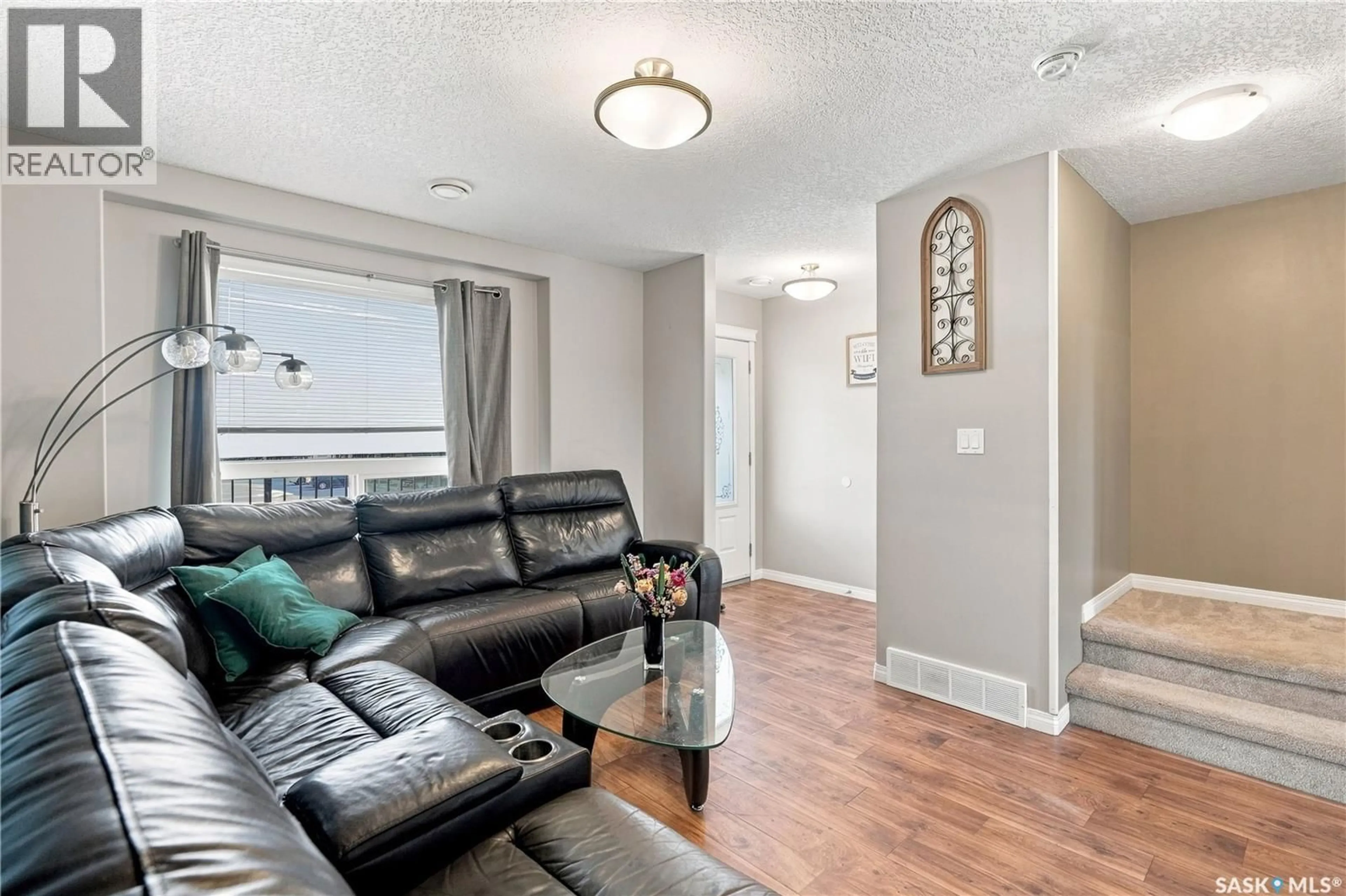 Living room with furniture, wood/laminate floor for 3802 - 812 DEWDNEY AVENUE, Regina Saskatchewan S4Z0A6