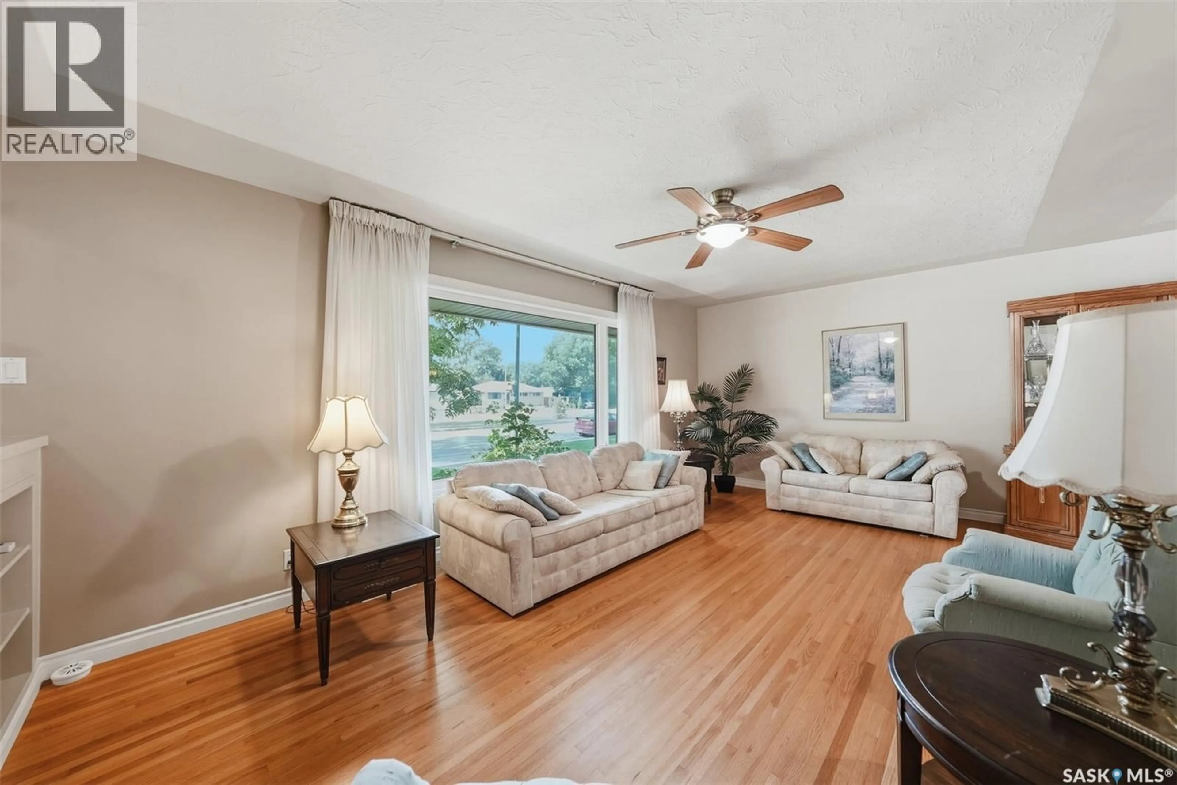 Living room with furniture, wood/laminate floor for 2809 CLARENCE AVENUE, Saskatoon Saskatchewan S7J1M7