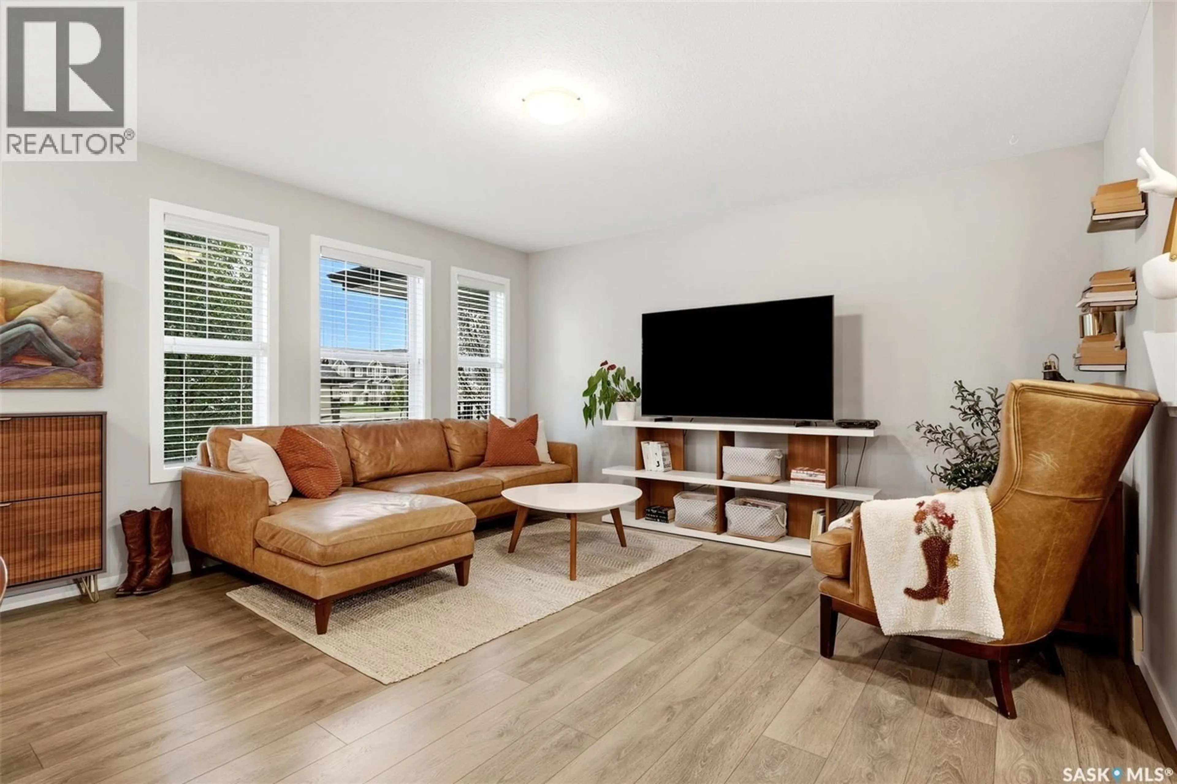 Living room with furniture, wood/laminate floor for 8008 CANOLA AVENUE, Regina Saskatchewan S4Y0E7