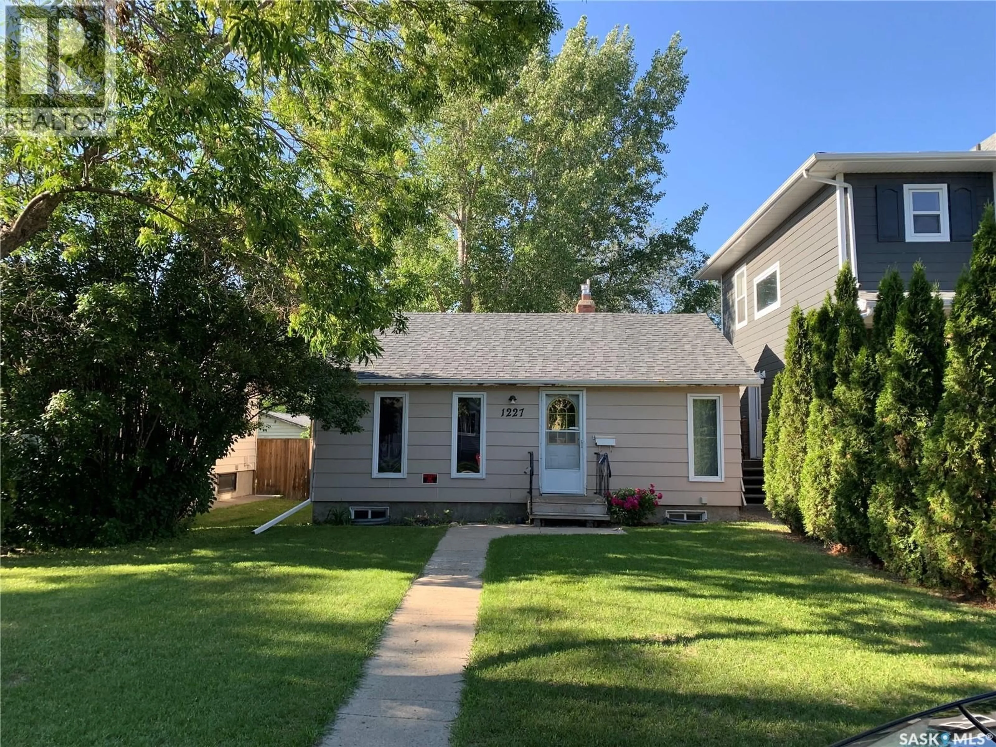Home with vinyl exterior material, street for 1227 13TH STREET, Saskatoon Saskatchewan S7H0C3