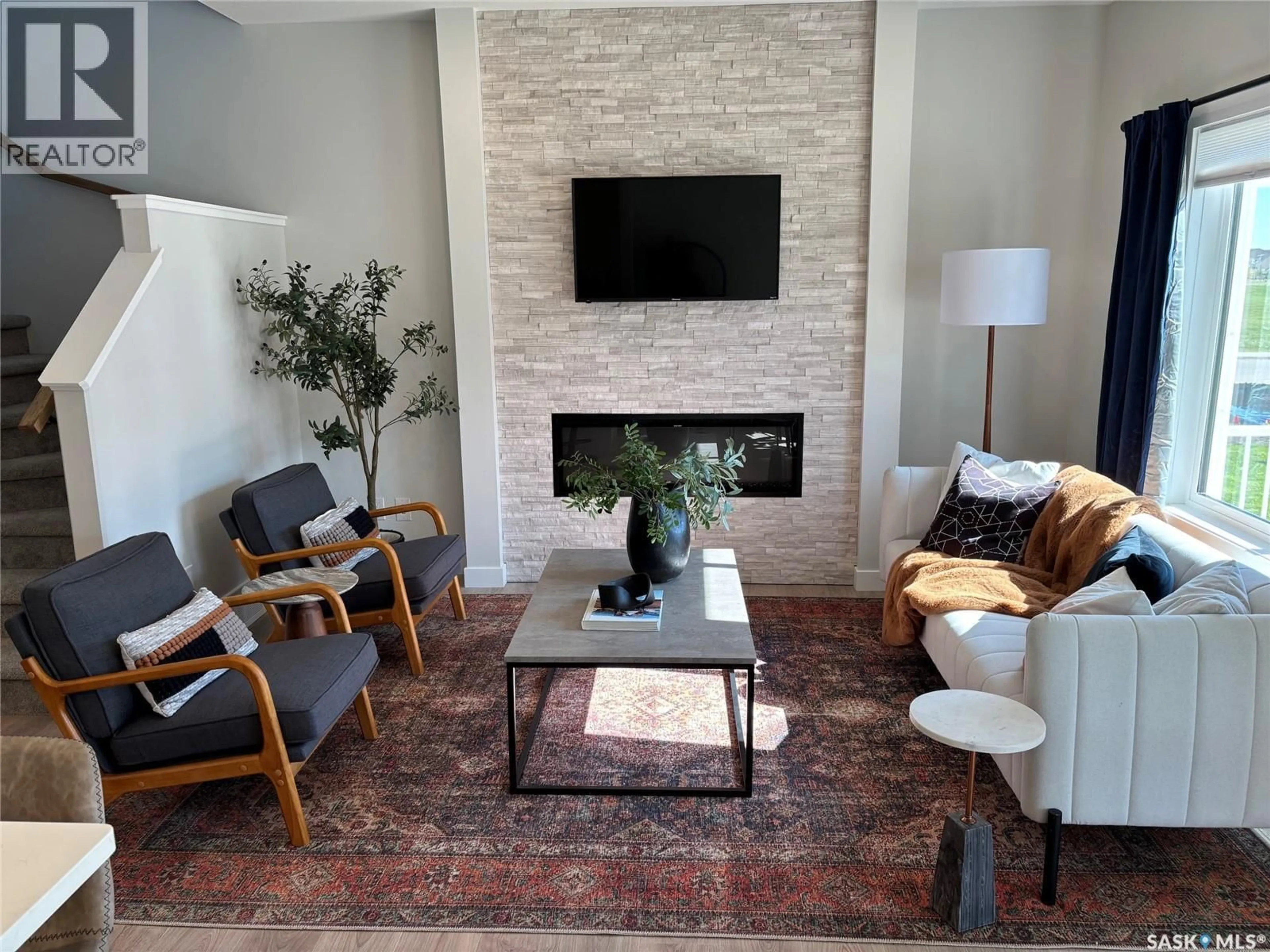 Living room with furniture, ceramic/tile floor for 242 ASOKANIHKEW CRESCENT, Saskatoon Saskatchewan S7V2C4