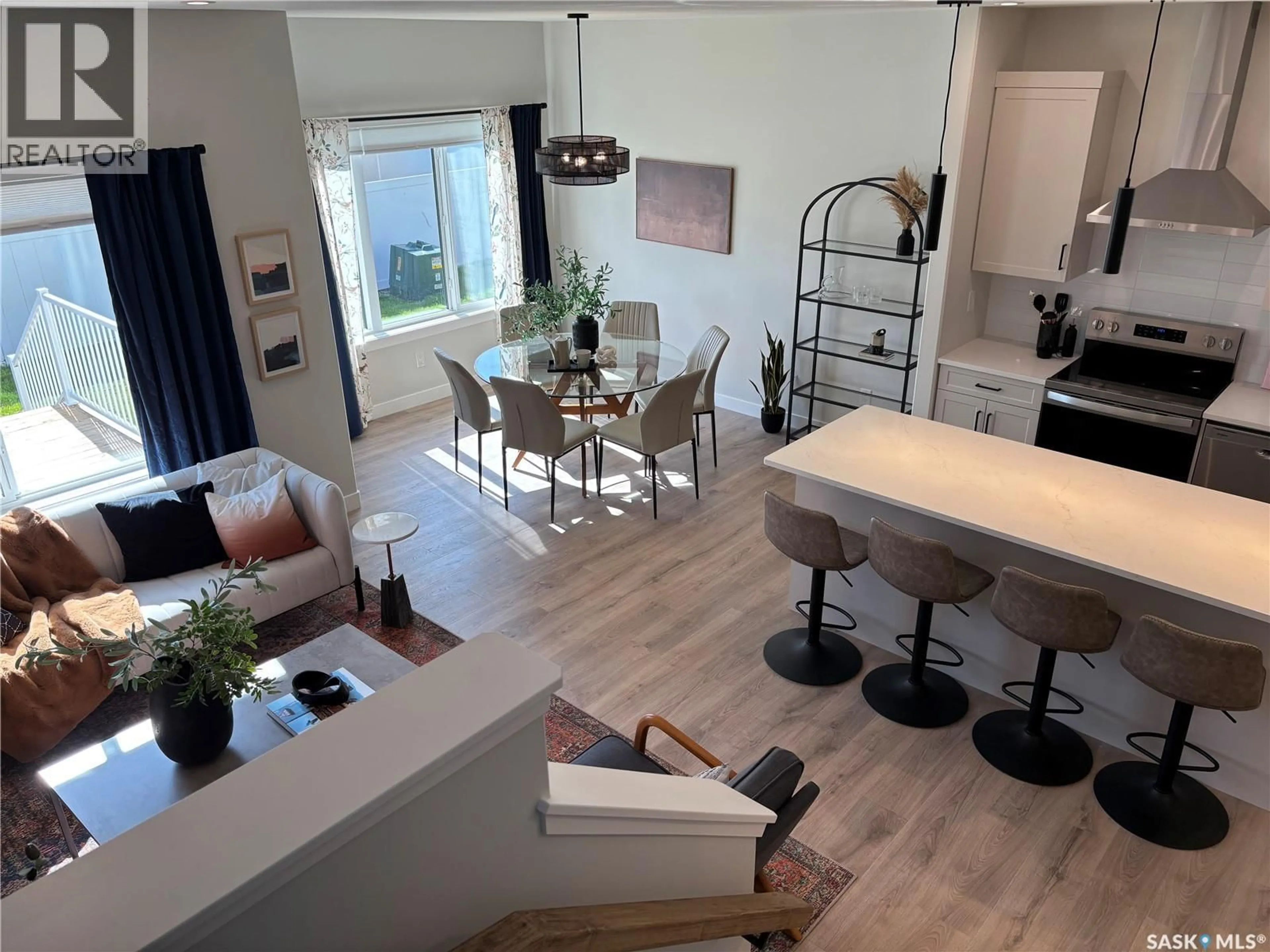 Open concept kitchen, wood/laminate floor for 242 ASOKANIHKEW CRESCENT, Saskatoon Saskatchewan S7V2C4