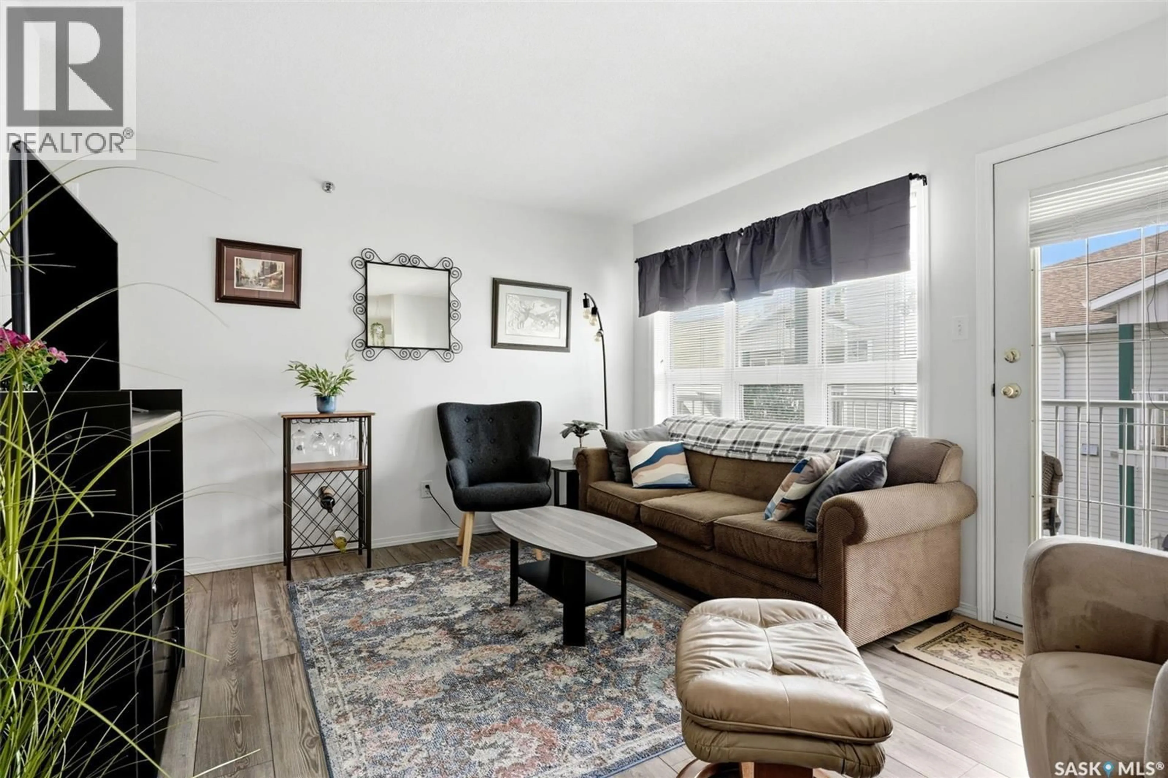 Living room with furniture, wood/laminate floor for 2203 - 403 ANGUS STREET, Regina Saskatchewan S4T2A3