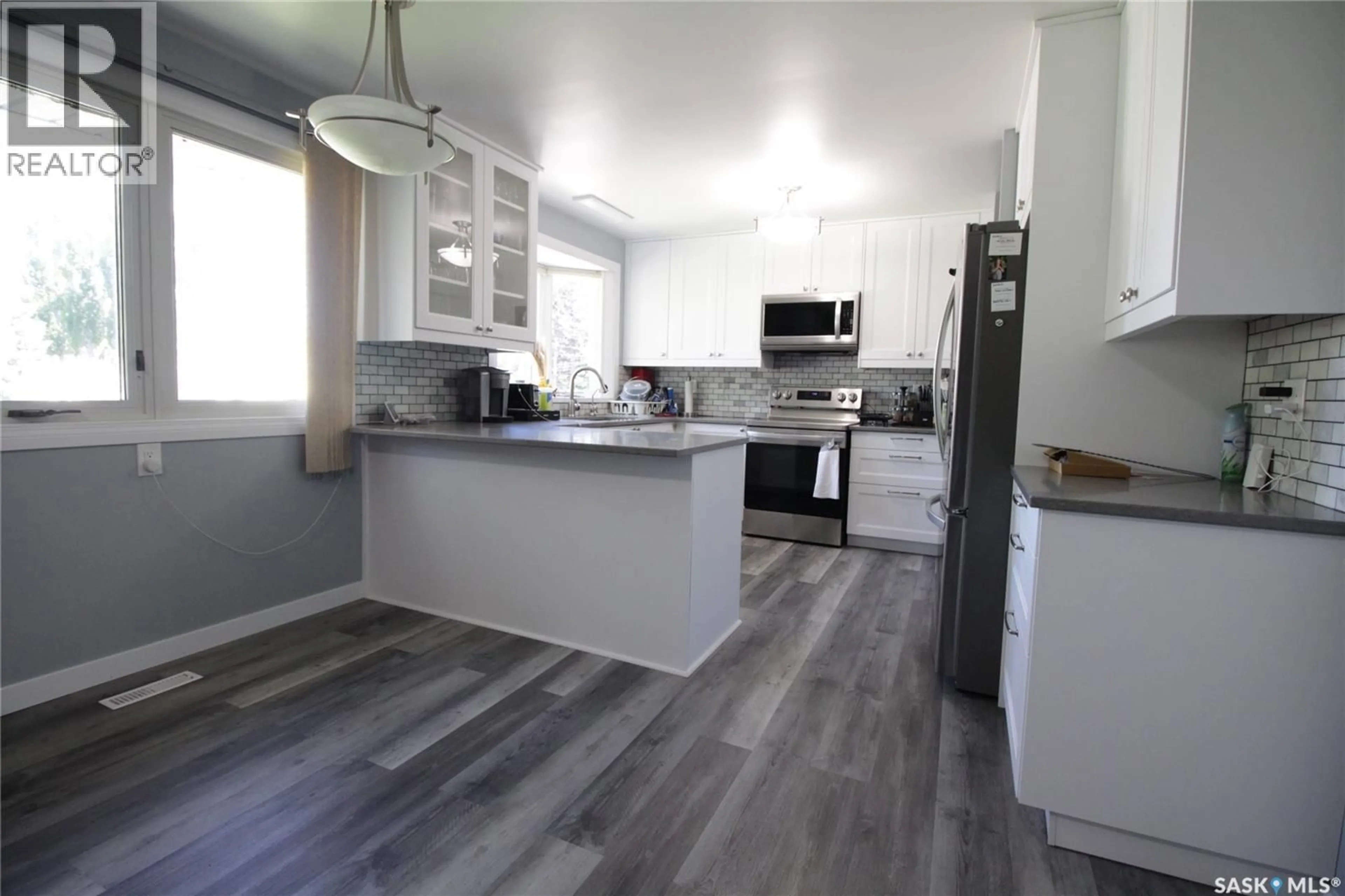 Open concept kitchen, wood/laminate floor for 1108 BOBOLINK BAY, Rocanville Saskatchewan S0A3L0