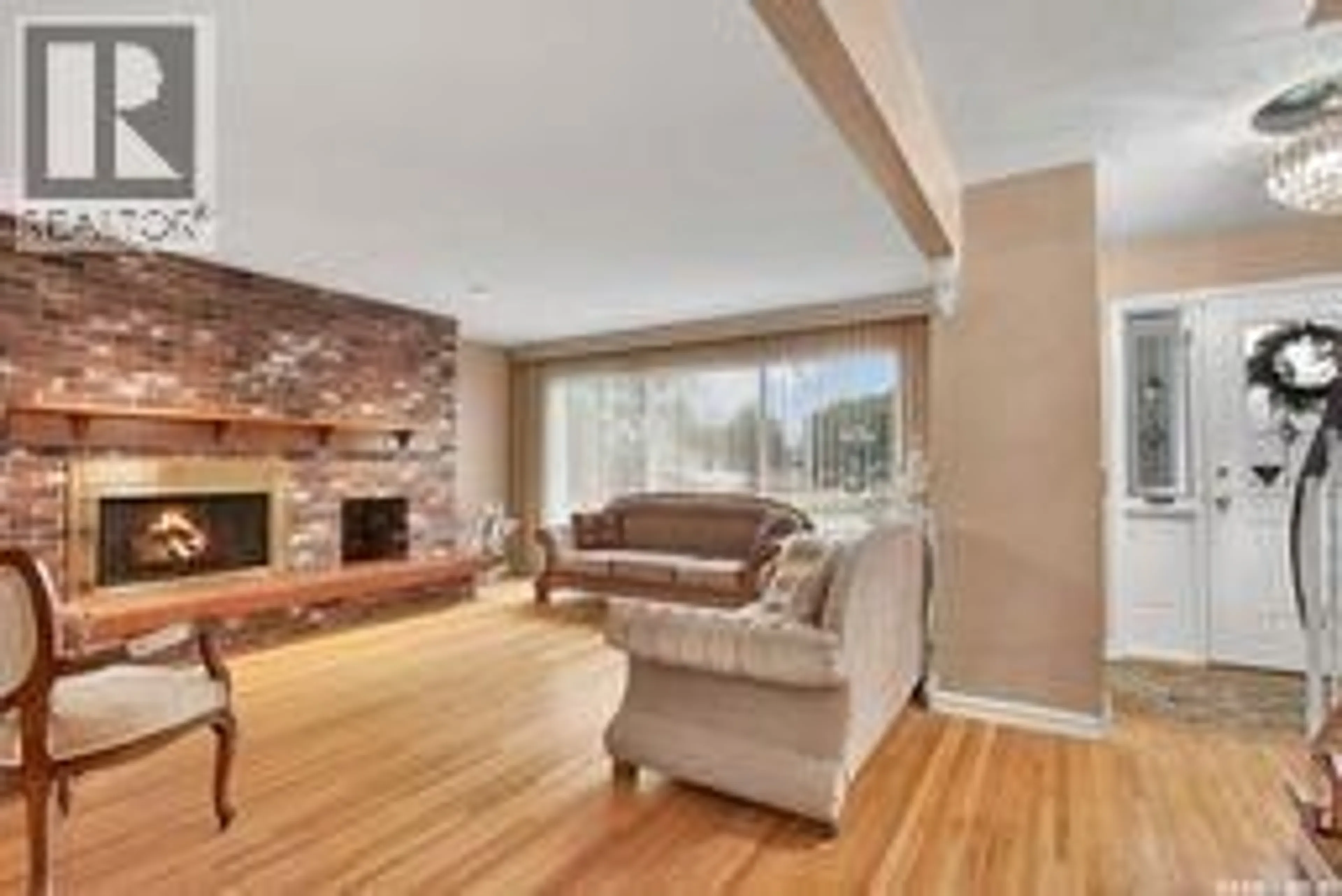 Living room with furniture, wood/laminate floor for 2429 CUMBERLAND AVENUE, Saskatoon Saskatchewan S7J1Z8