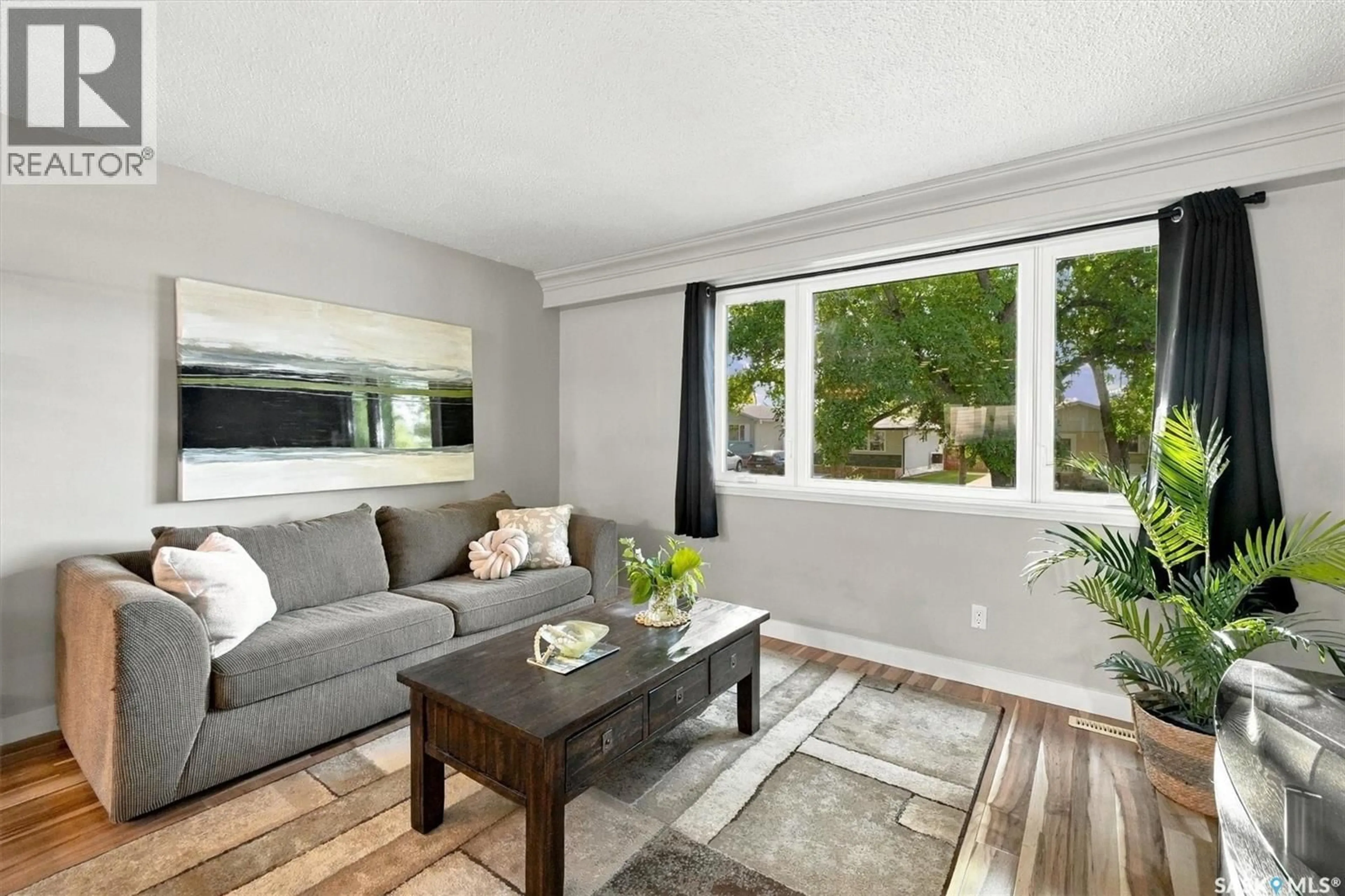 Living room with furniture, wood/laminate floor for 134 ROSS CRESCENT, Saskatoon Saskatchewan S7L4B3