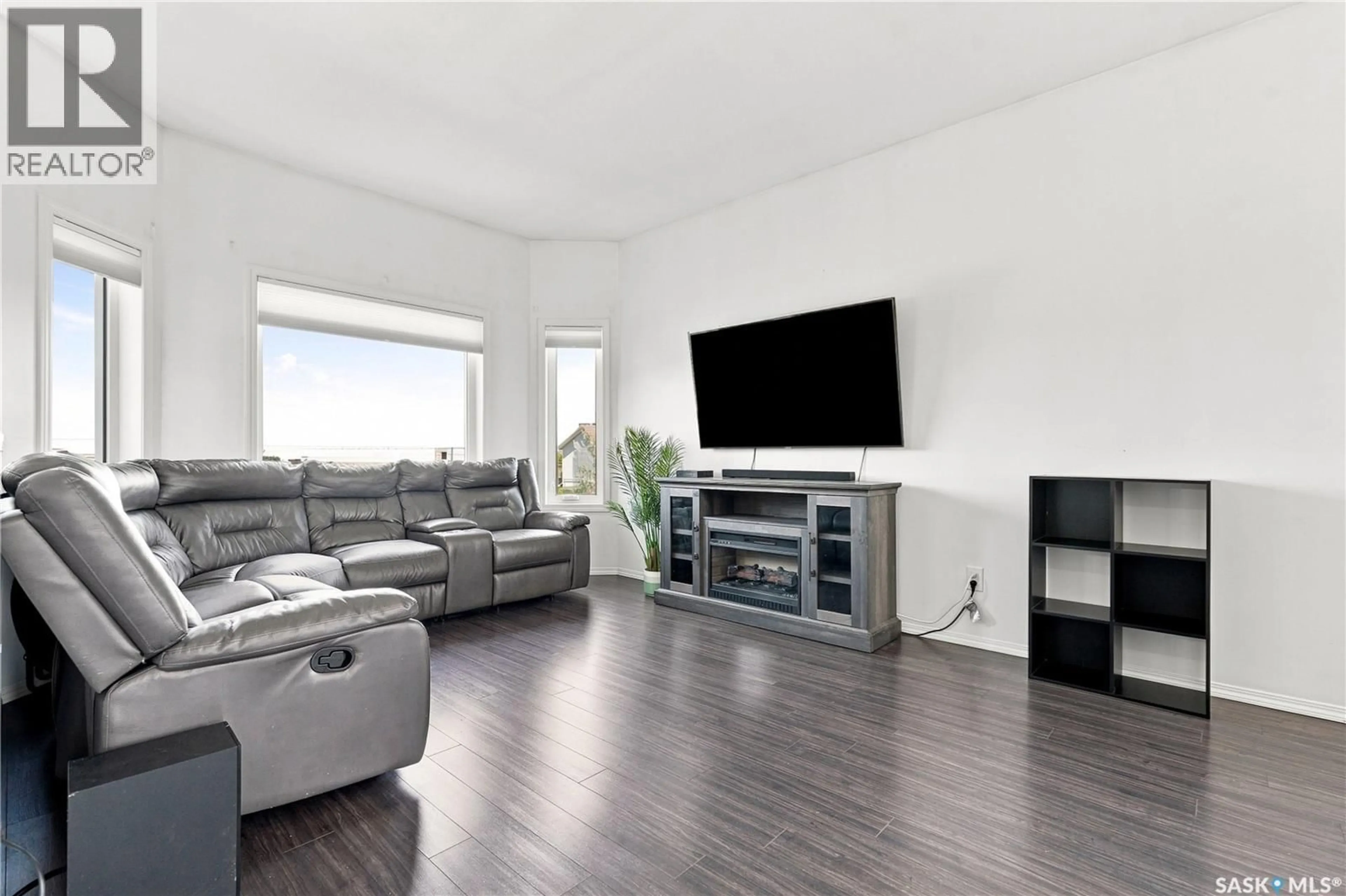 Living room with furniture, wood/laminate floor for 104 MCDONALD STREET, Aberdeen Saskatchewan S0K0A2