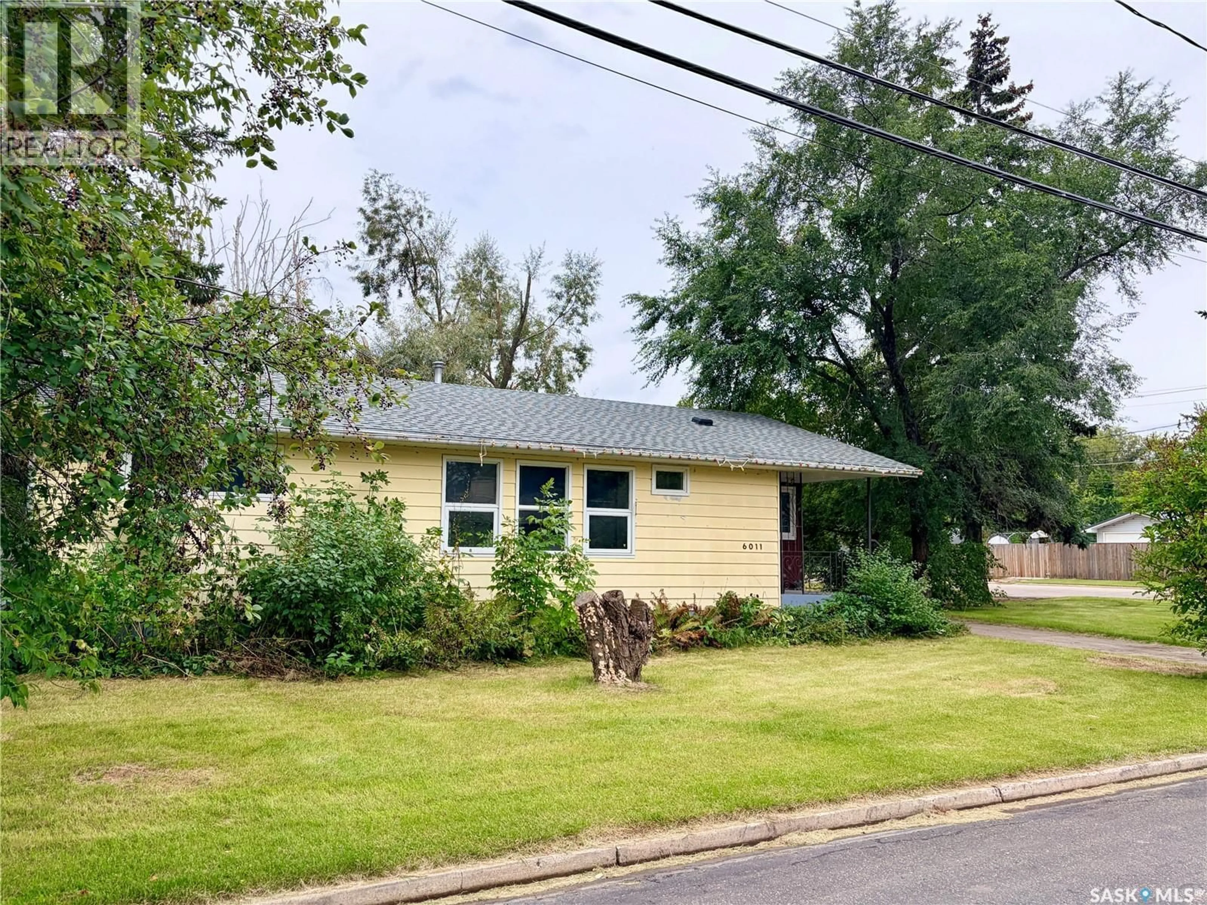 Home with vinyl exterior material, street for 6011 5TH STREET, Rosthern Saskatchewan S0K2H0