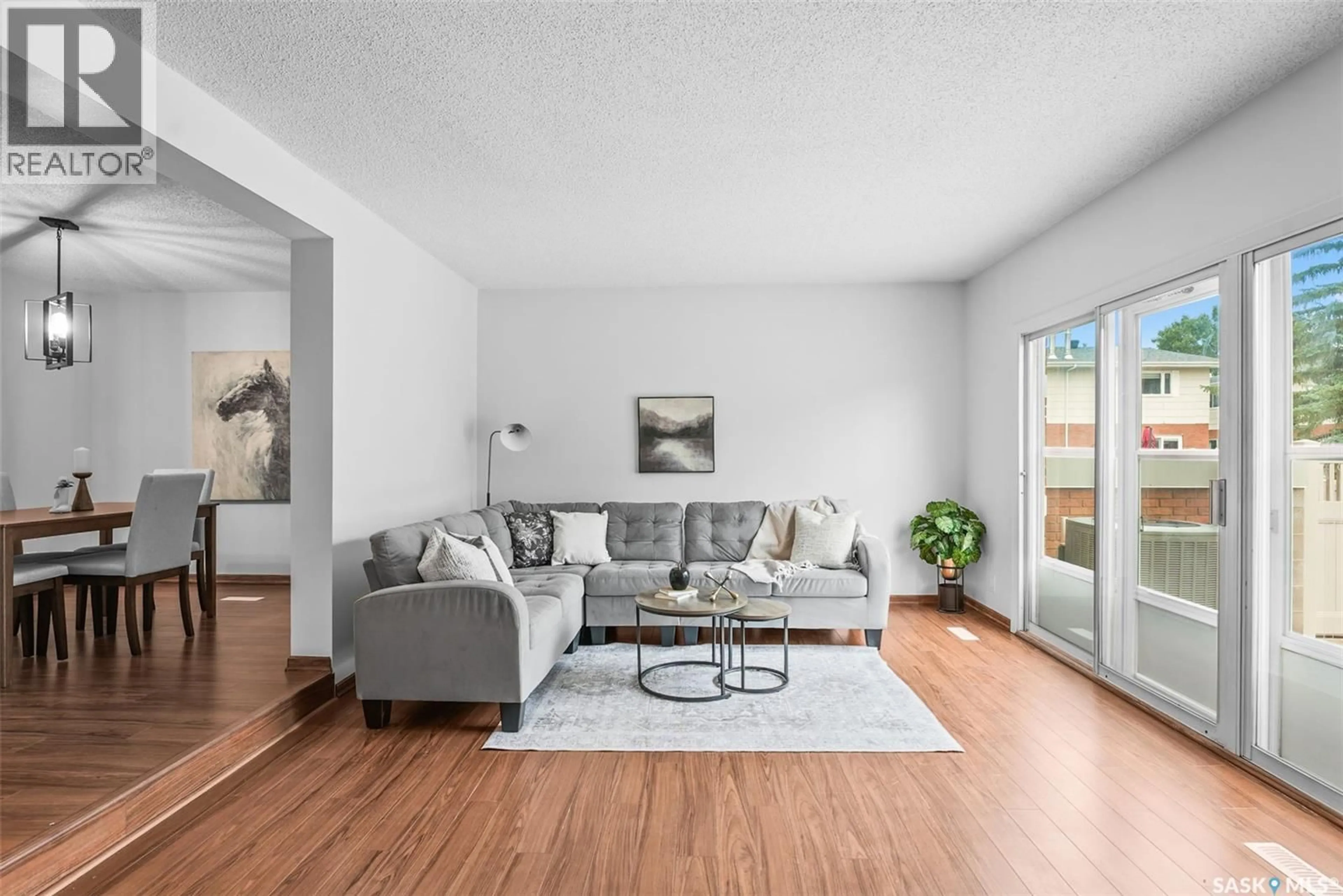 Living room with furniture, wood/laminate floor for 156 PLAINSVIEW DRIVE, Regina Saskatchewan S4S6L2