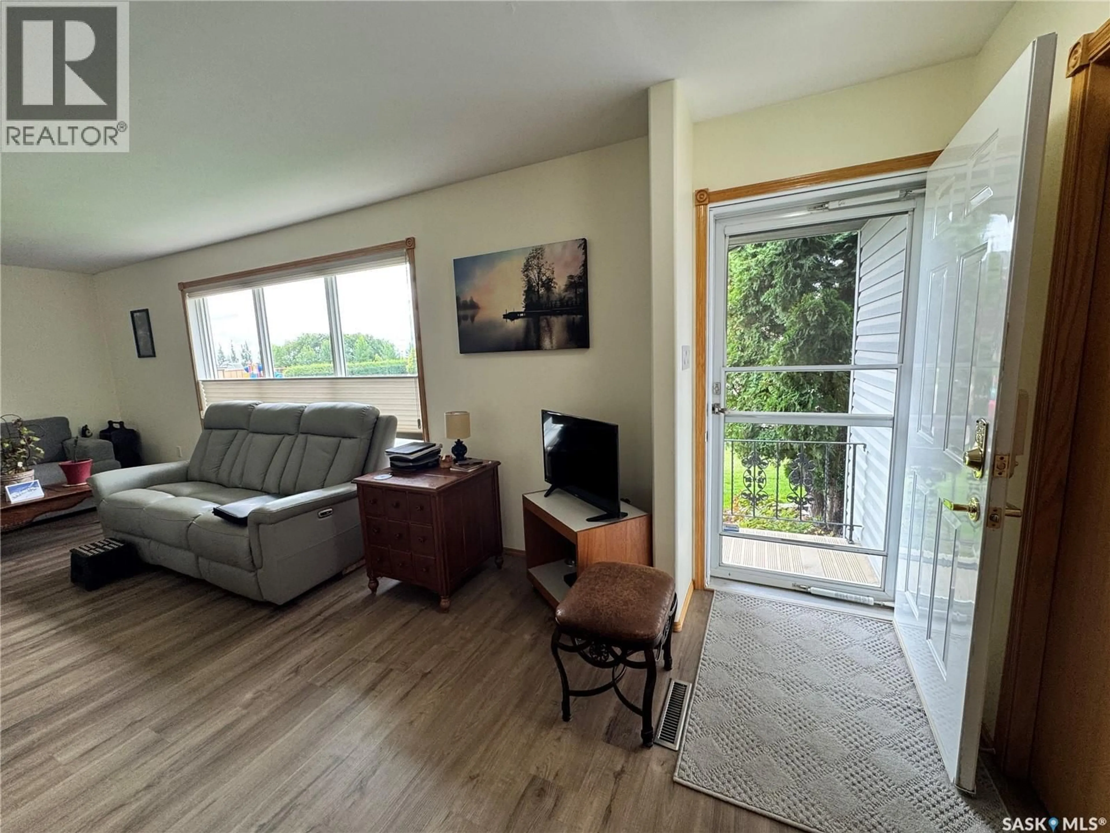 Living room with furniture, wood/laminate floor for 616 8TH AVENUE, Biggar Saskatchewan S0K0M0