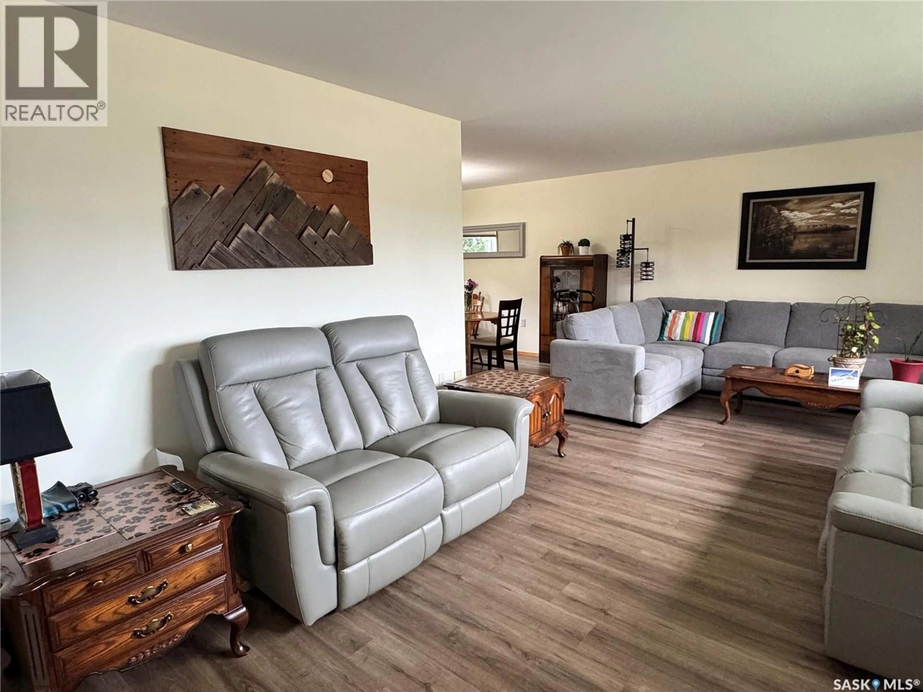 Living room with furniture, wood/laminate floor for 616 8TH AVENUE, Biggar Saskatchewan S0K0M0
