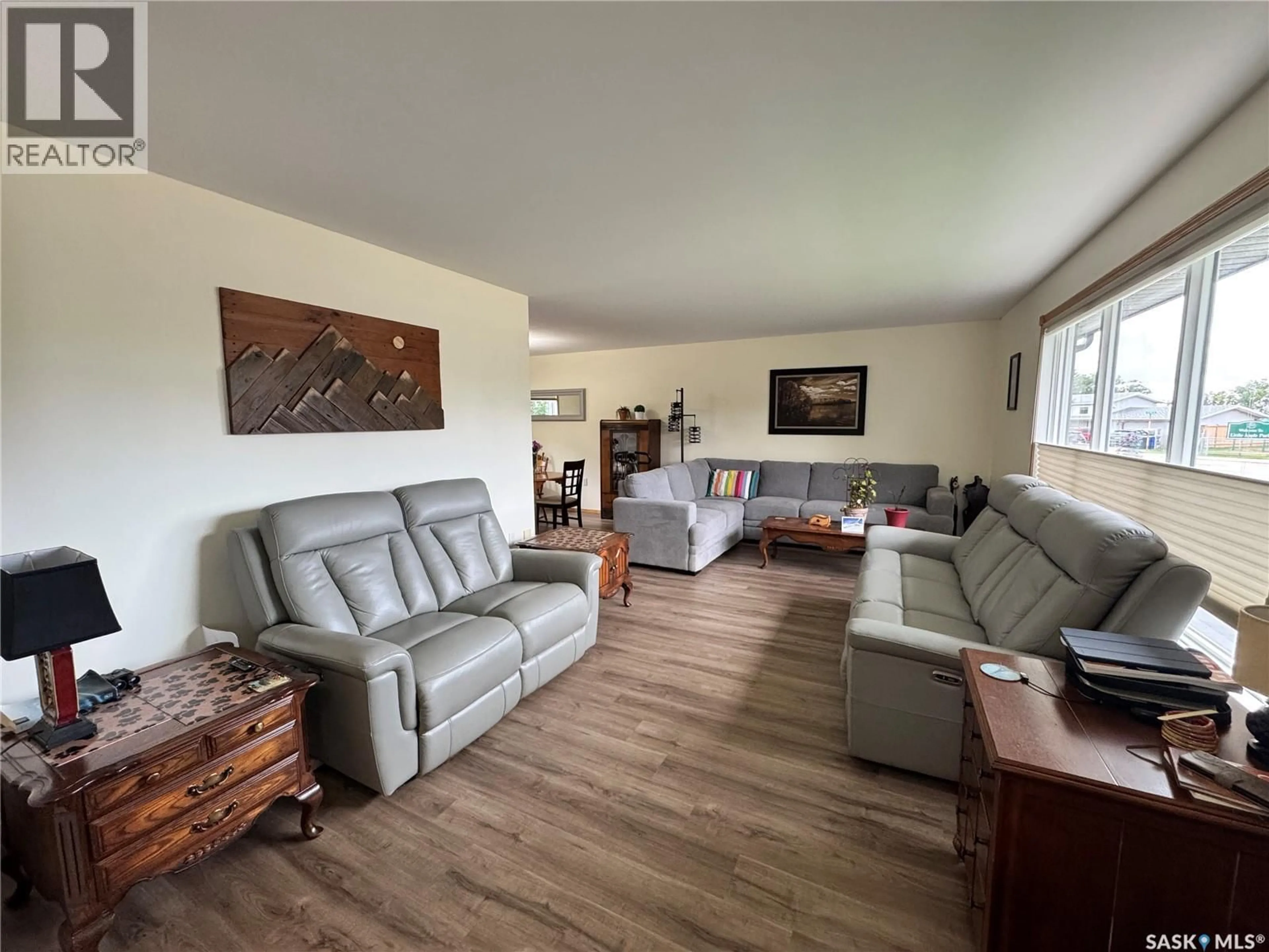 Living room with furniture, wood/laminate floor for 616 8TH AVENUE, Biggar Saskatchewan S0K0M0