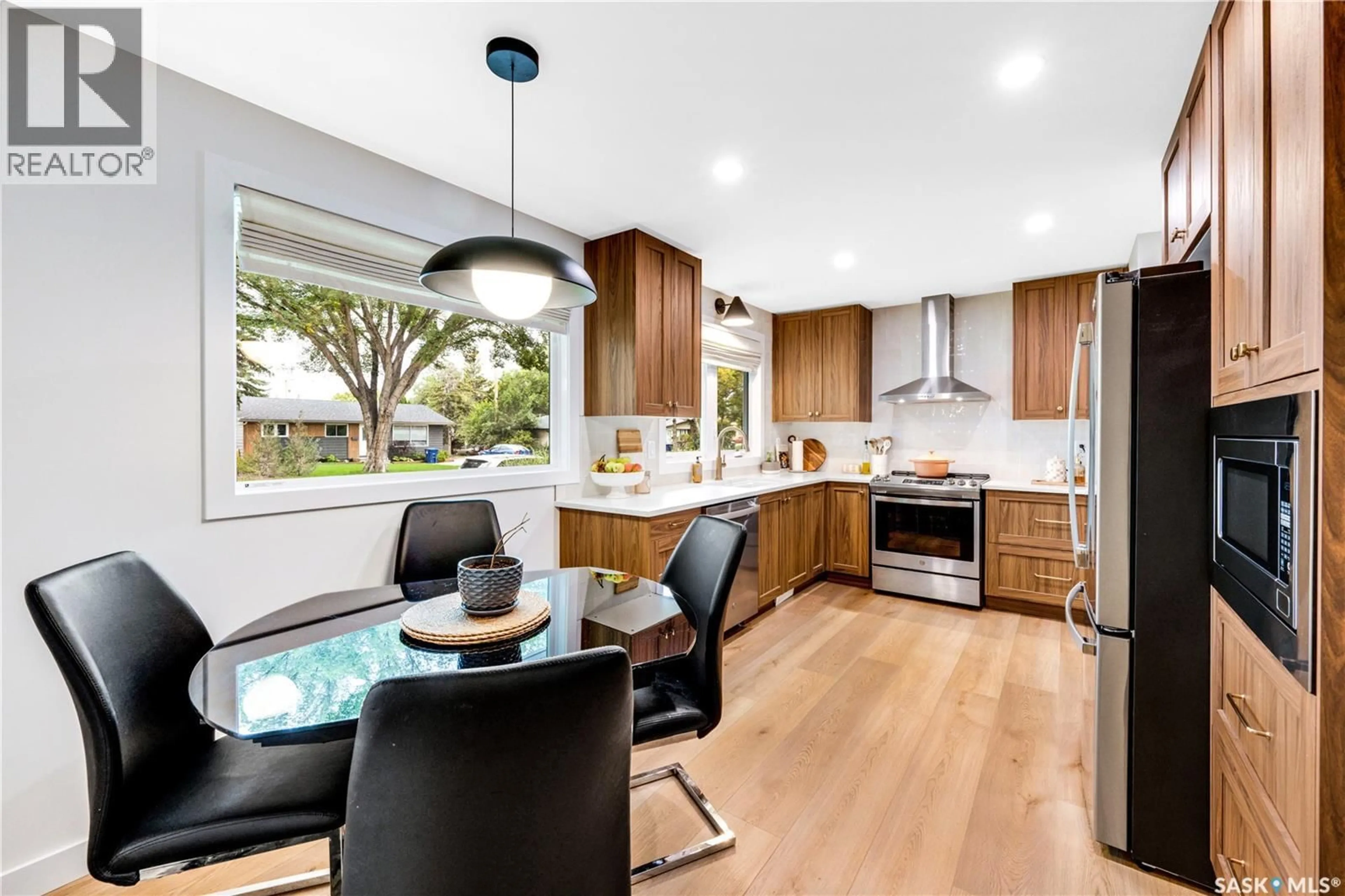 Open concept kitchen, wood/laminate floor for 1313 CONN AVENUE, Saskatoon Saskatchewan S7H3K9