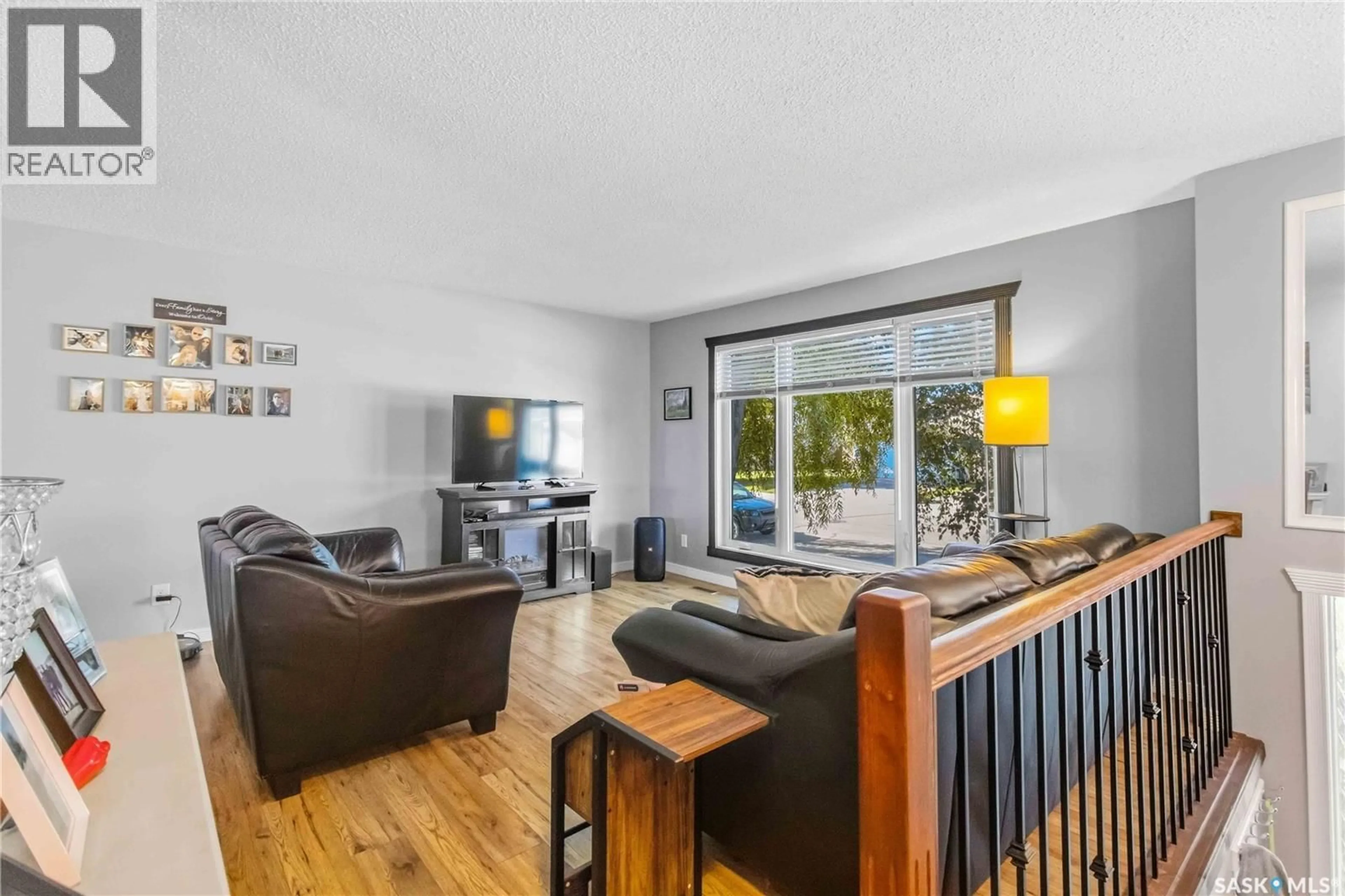 Living room with furniture, wood/laminate floor for 430 BALL WAY, Saskatoon Saskatchewan S7K6E7