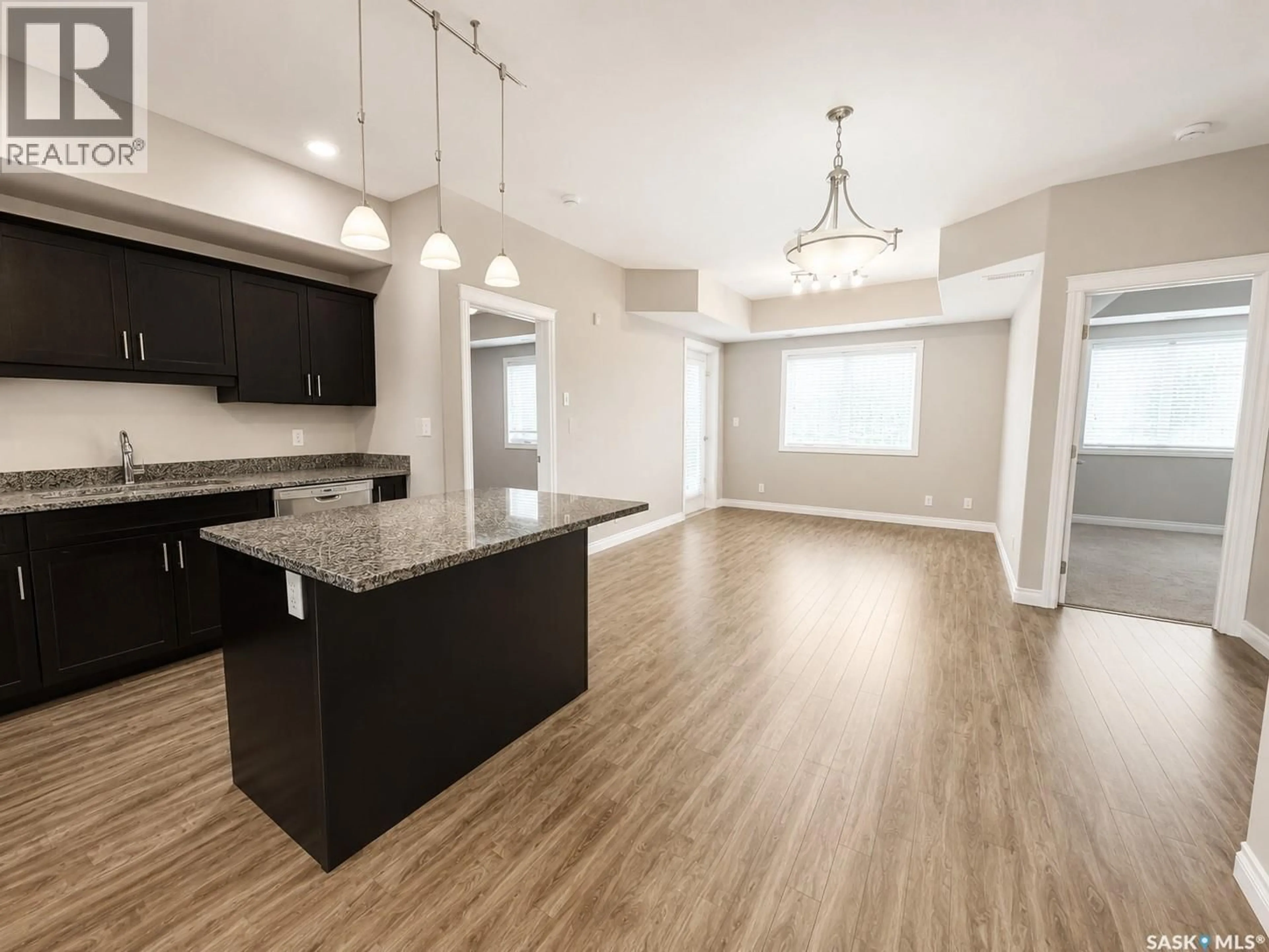 Open concept kitchen, wood/laminate floor for 412 - 309 WILLOWGROVE SQUARE, Saskatoon Saskatchewan S7W0E5