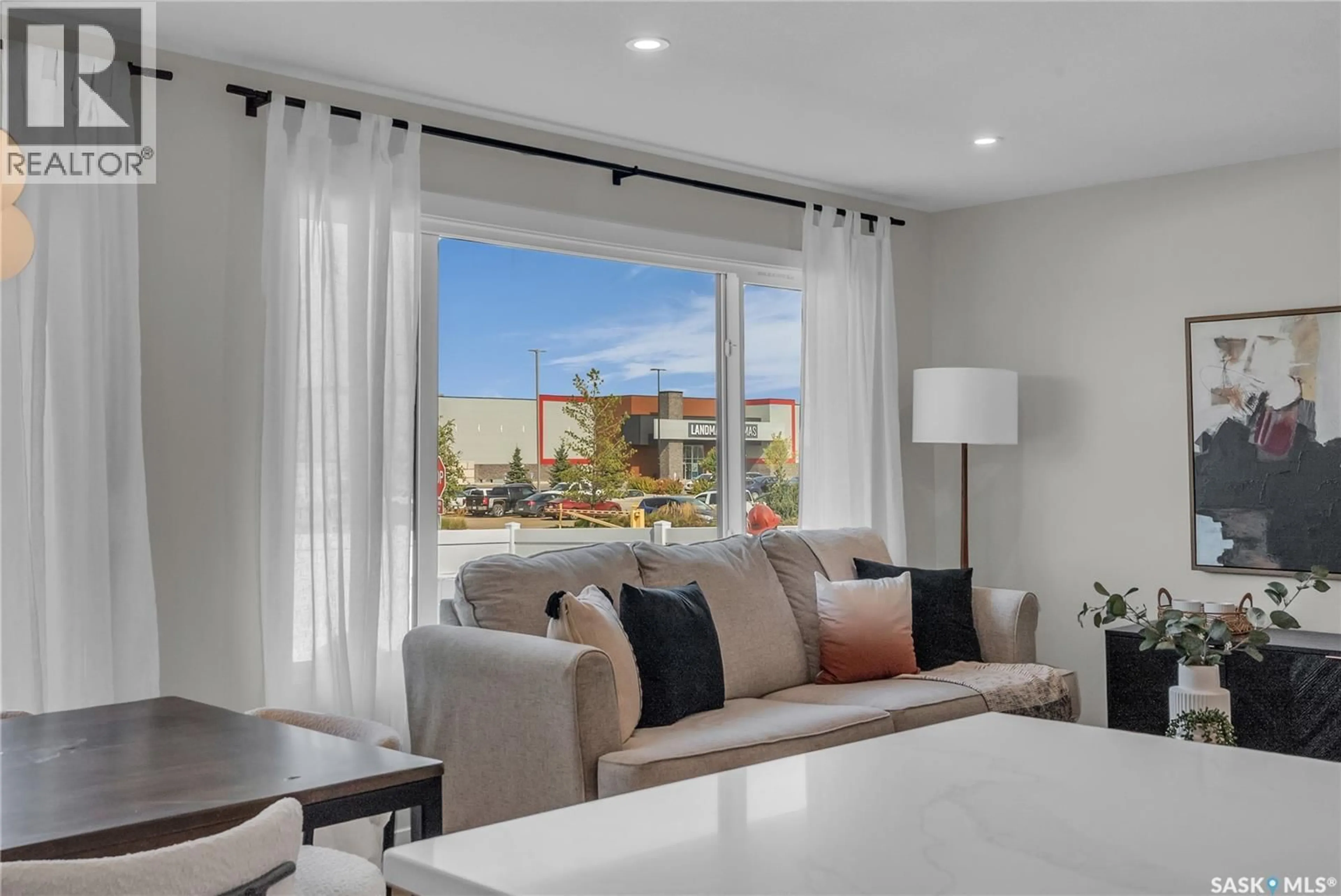 Living room with furniture, ceramic/tile floor for 136 155 MCFAULL WAY, Saskatoon Saskatchewan S7V1Z9