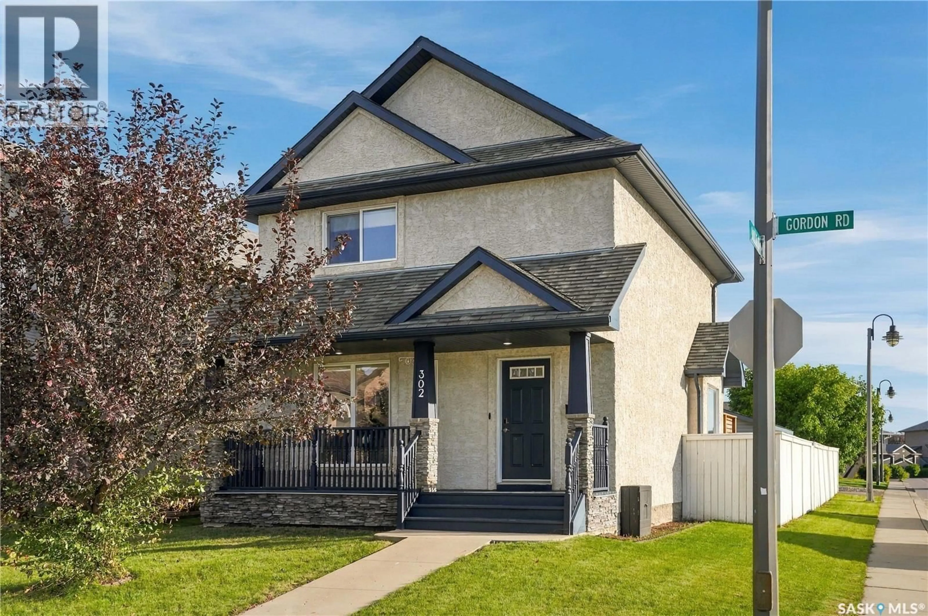 Home with vinyl exterior material, street for 302 GORDON ROAD, Saskatoon Saskatchewan S7T0A3