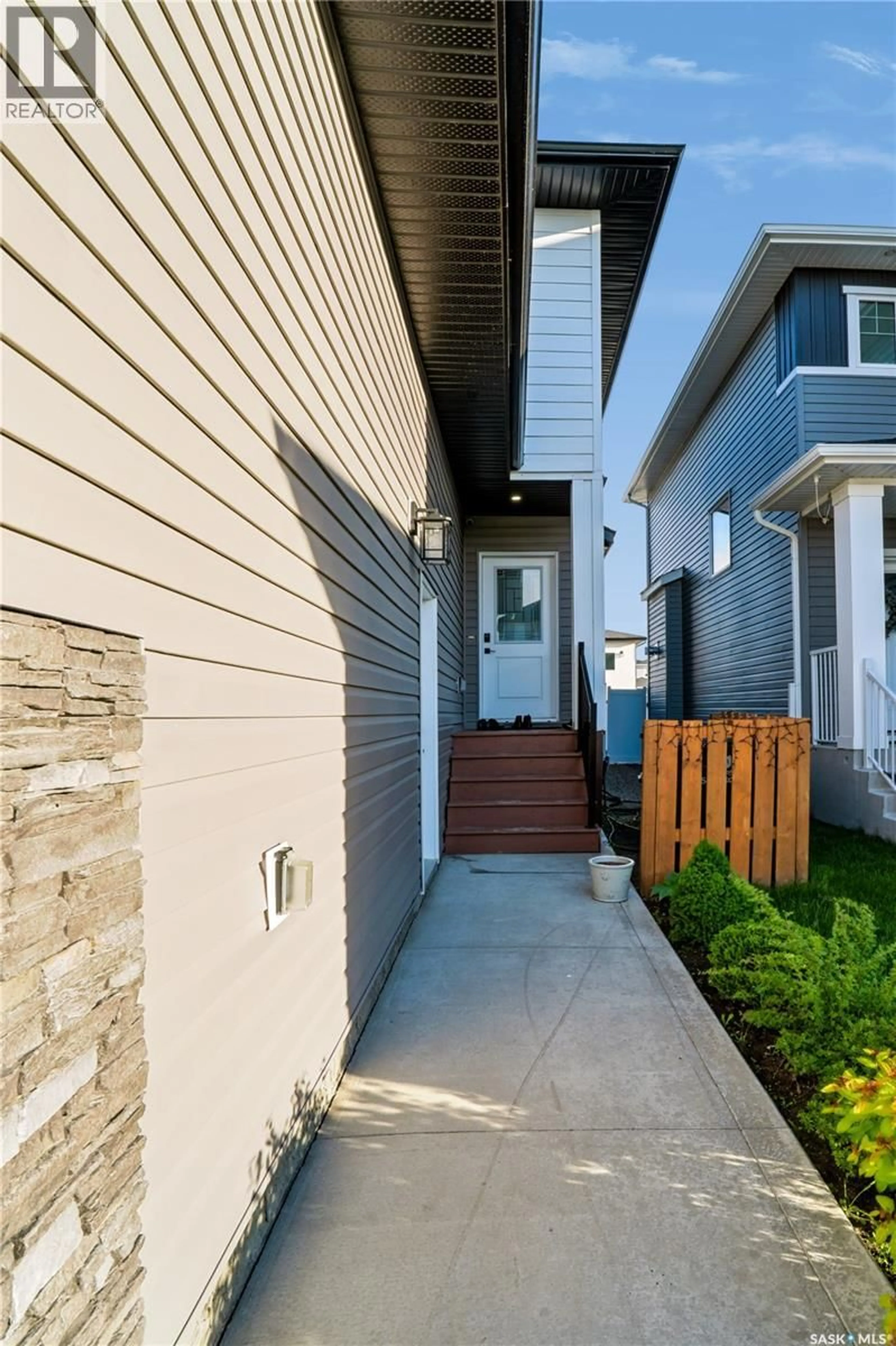 Home with vinyl exterior material, street for 164 THAKUR STREET, Saskatoon Saskatchewan S7W1C4