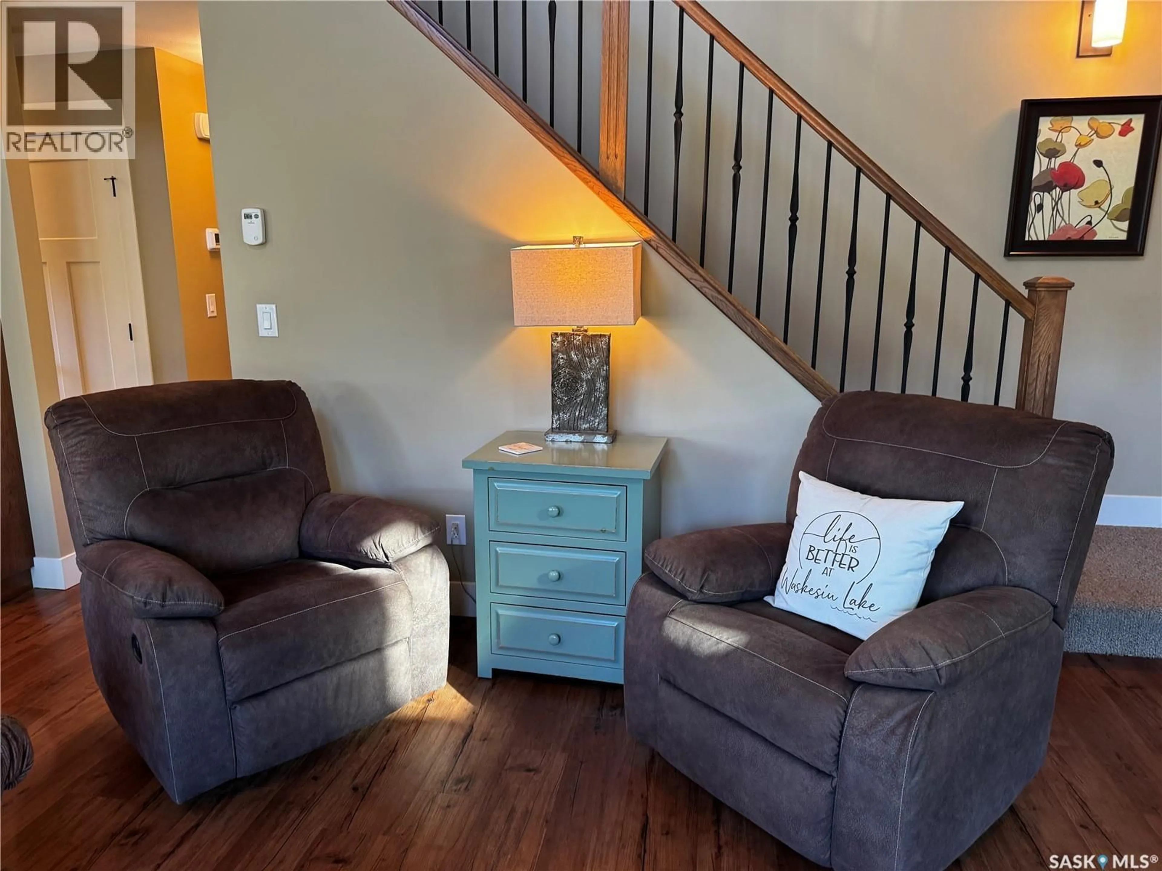 Living room with furniture, wood/laminate floor for 11 COTTAGE CRESCENT, Elk Ridge Saskatchewan S0J2Y0
