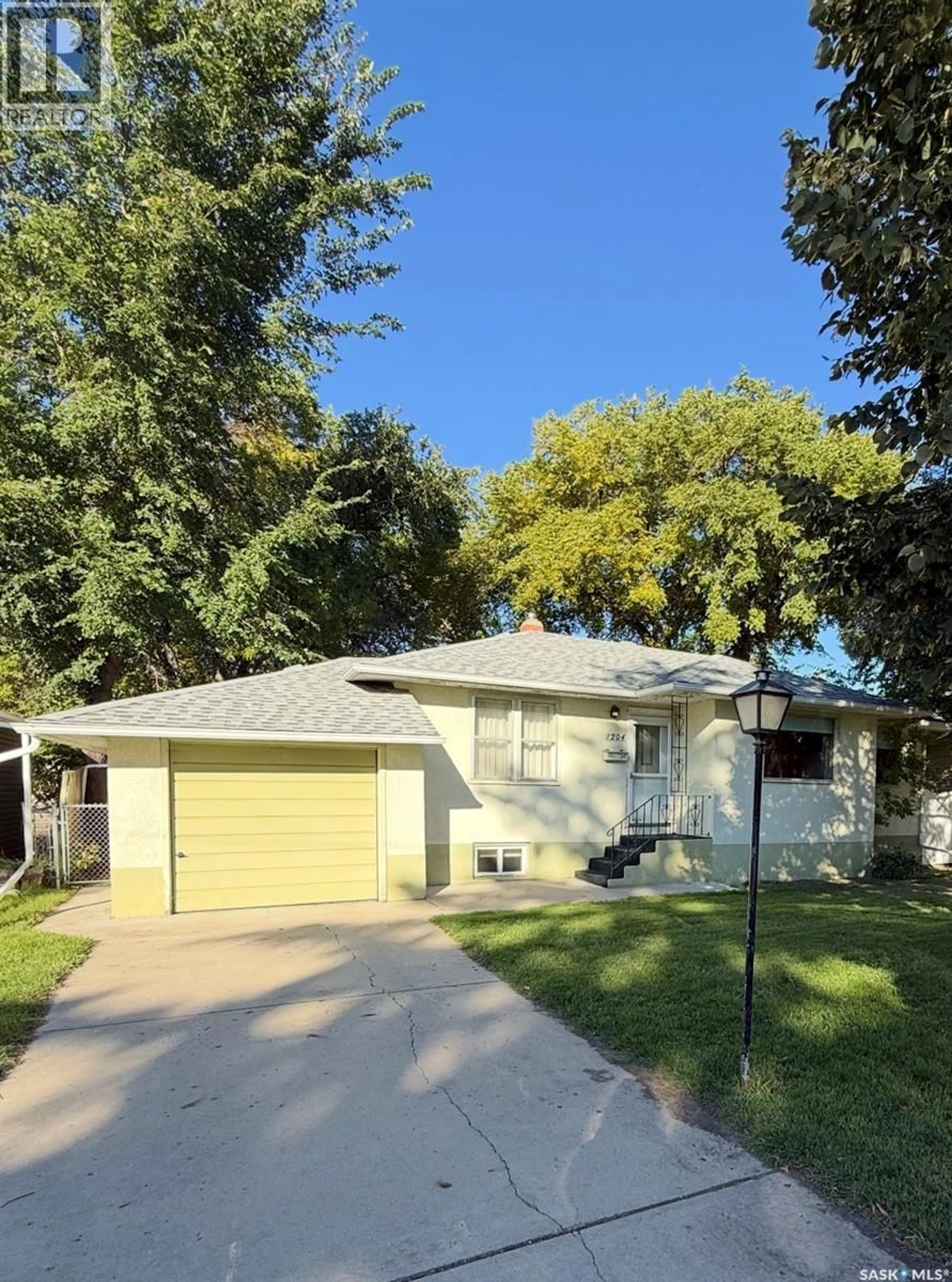 Home with vinyl exterior material, street for 1204 EWART AVENUE, Saskatoon Saskatchewan S7H2K3