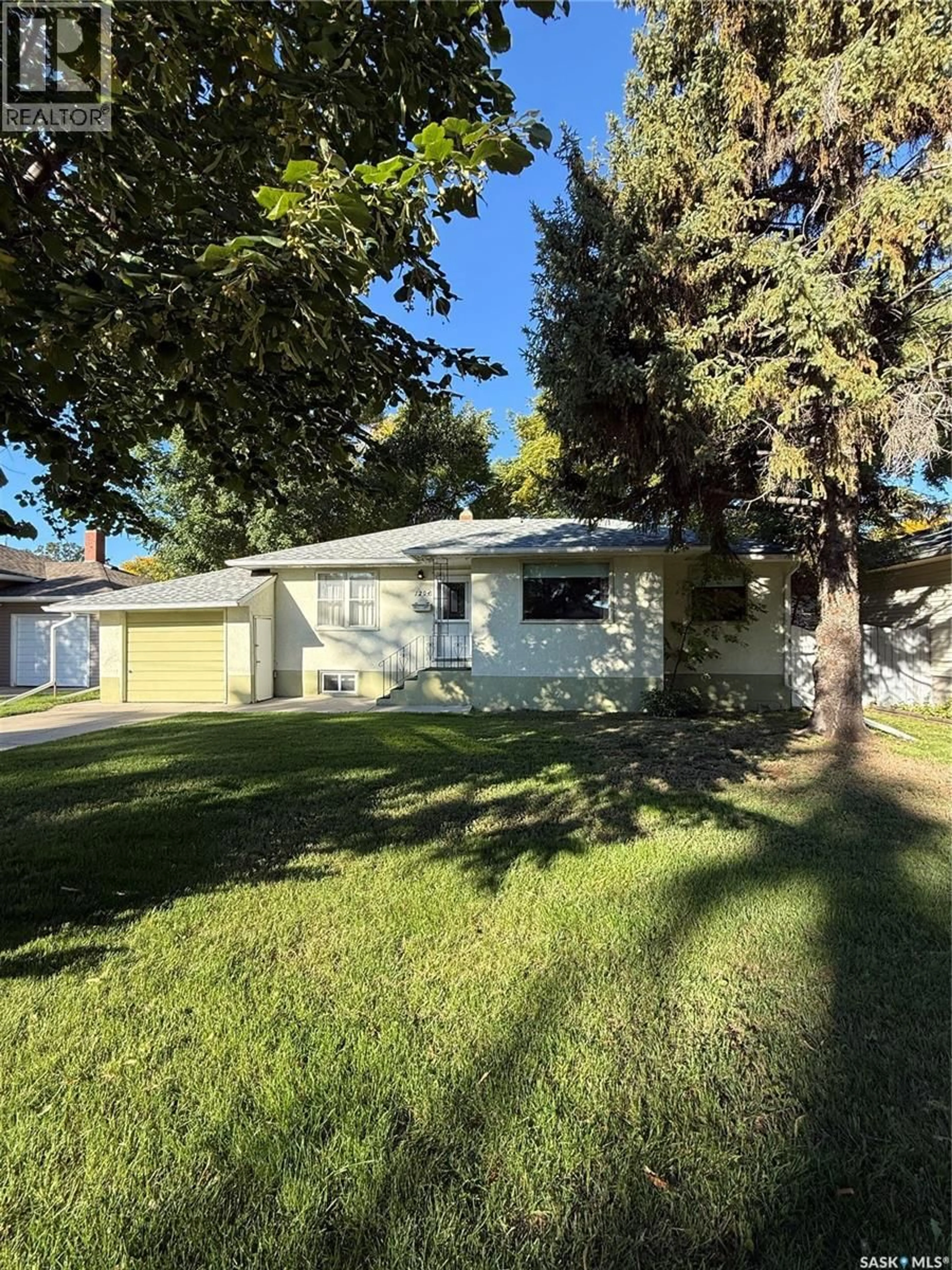 Home with vinyl exterior material, street for 1204 EWART AVENUE, Saskatoon Saskatchewan S7H2K3