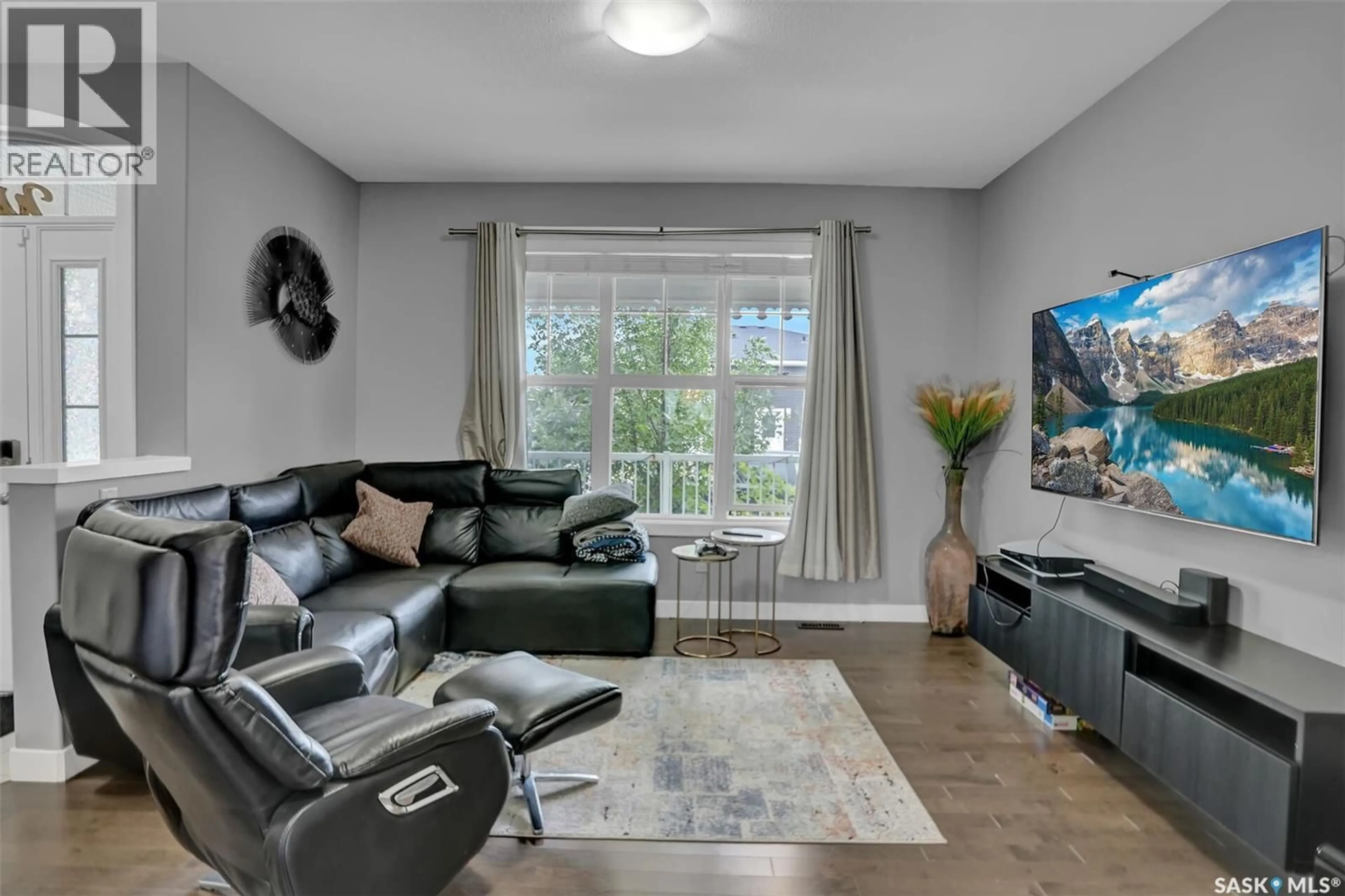 Living room with furniture, wood/laminate floor for 4305 SENECAL DRIVE, Regina Saskatchewan S4W0R1