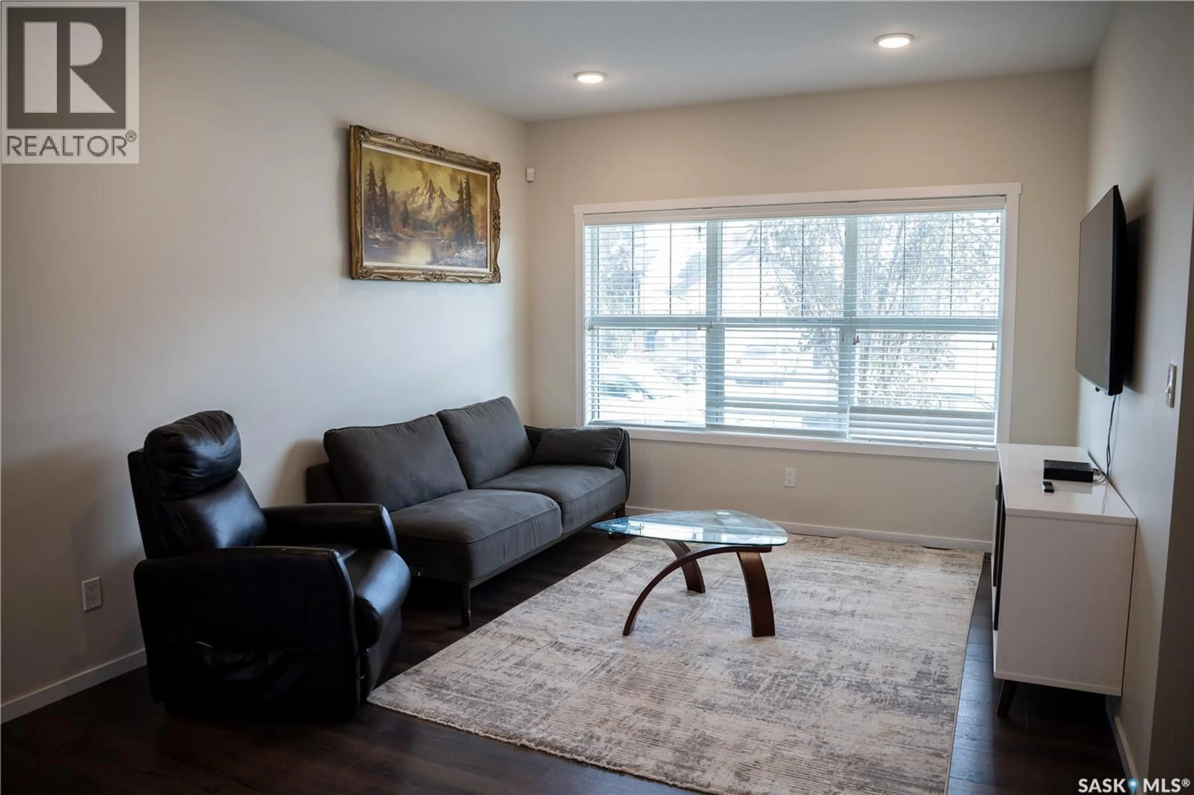 Living room with furniture, wood/laminate floor for 3418 GREEN TURTLE ROAD, Regina Saskatchewan S4V3N7