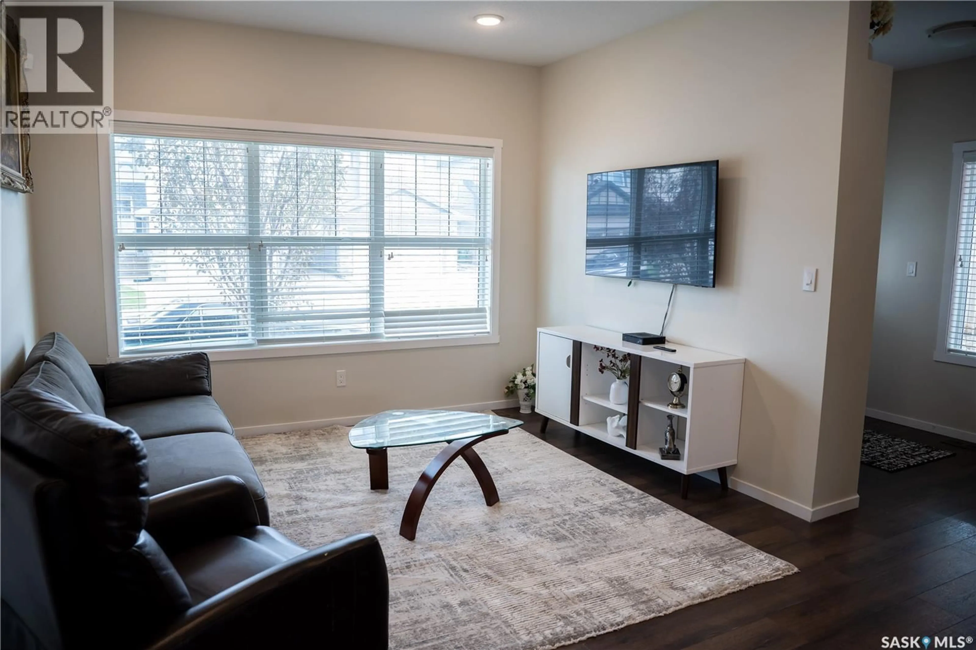 Living room with furniture, wood/laminate floor for 3418 GREEN TURTLE ROAD, Regina Saskatchewan S4V3N7