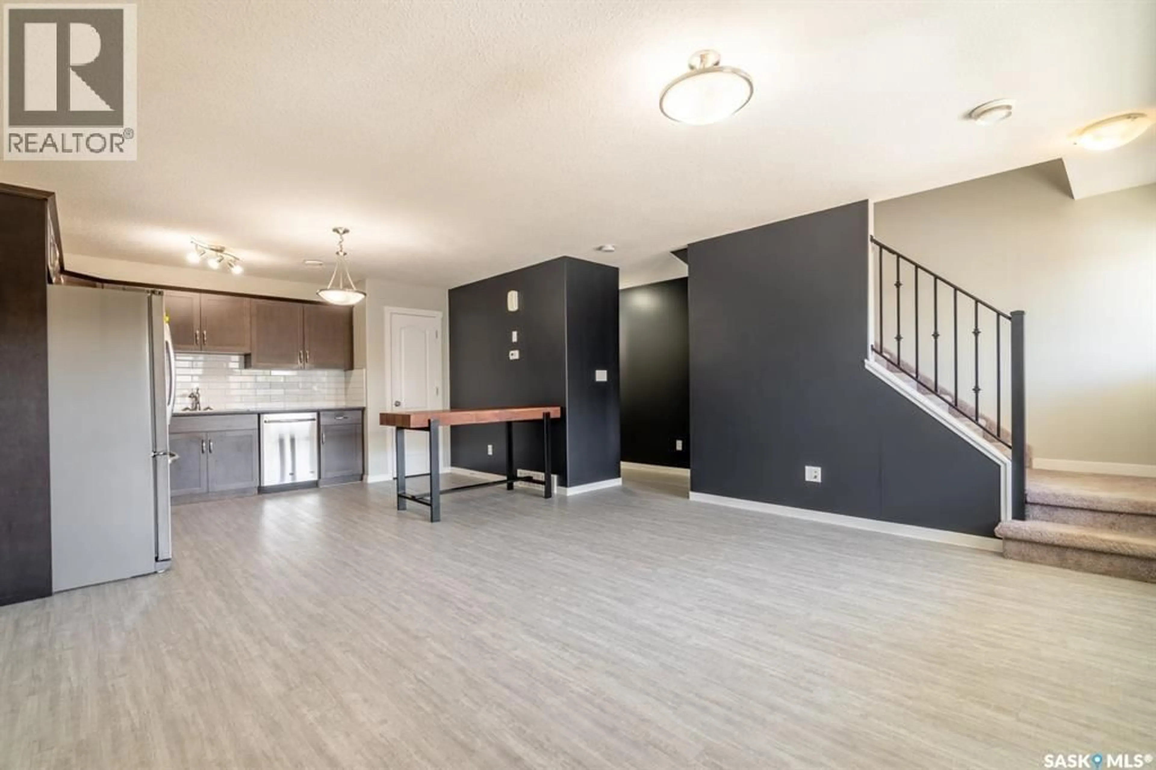 Open concept kitchen, wood/laminate floor for 113 - 1210 EMPRESS STREET, Regina Saskatchewan S4T1G7