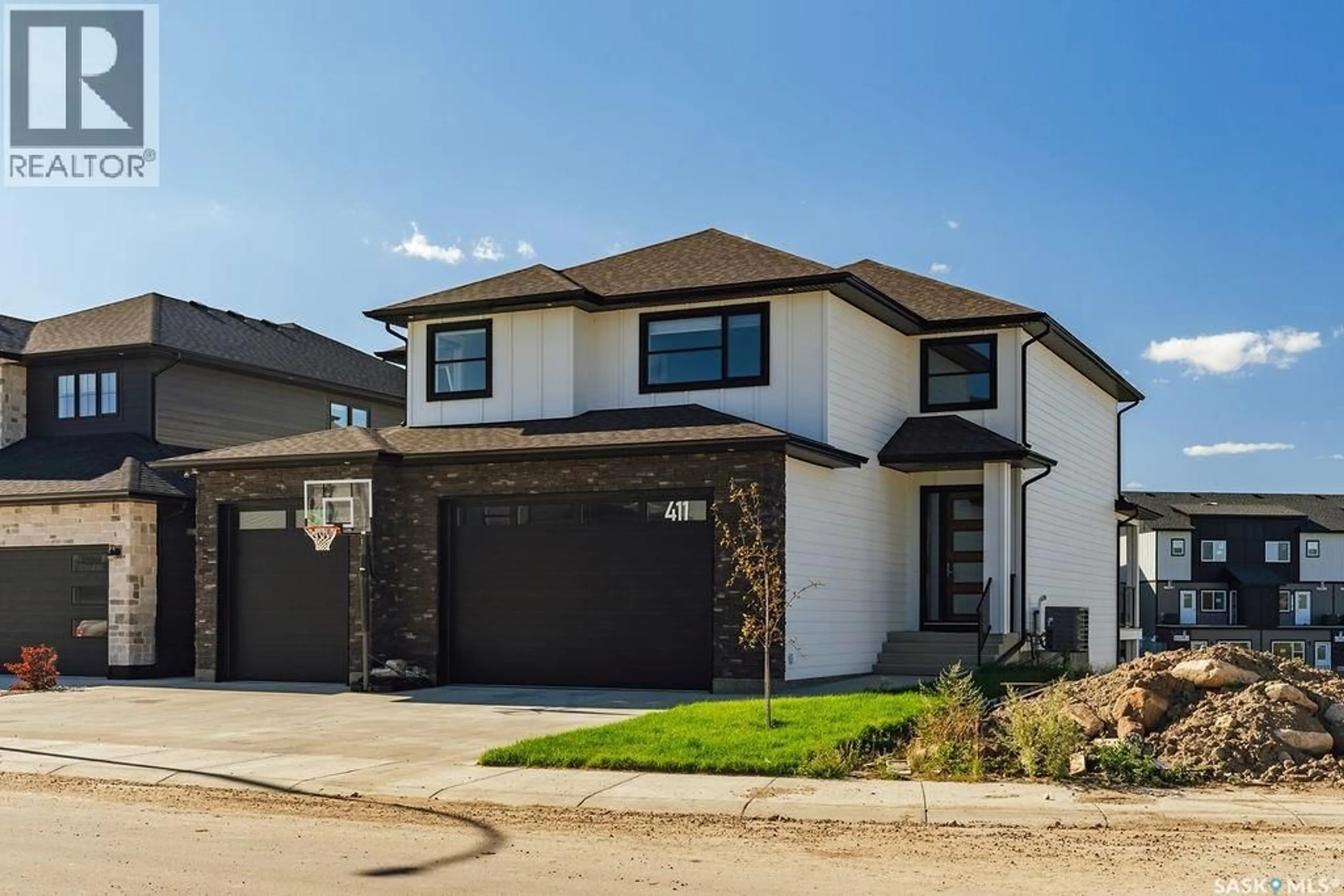 Home with brick exterior material, street for 411 SHARMA CRESCENT, Saskatoon Saskatchewan S7W0Y4