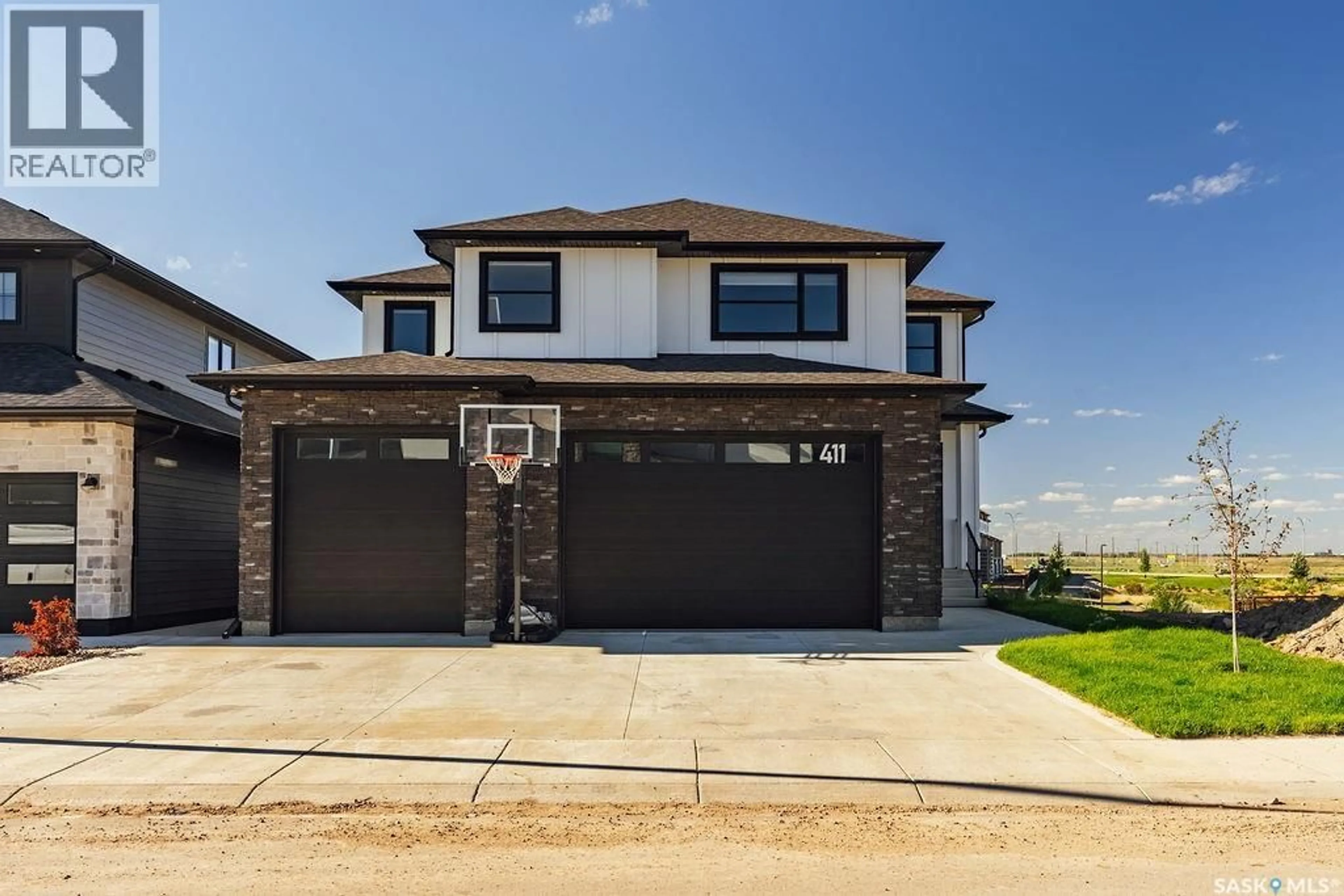 Home with brick exterior material, street for 411 SHARMA CRESCENT, Saskatoon Saskatchewan S7W0Y4
