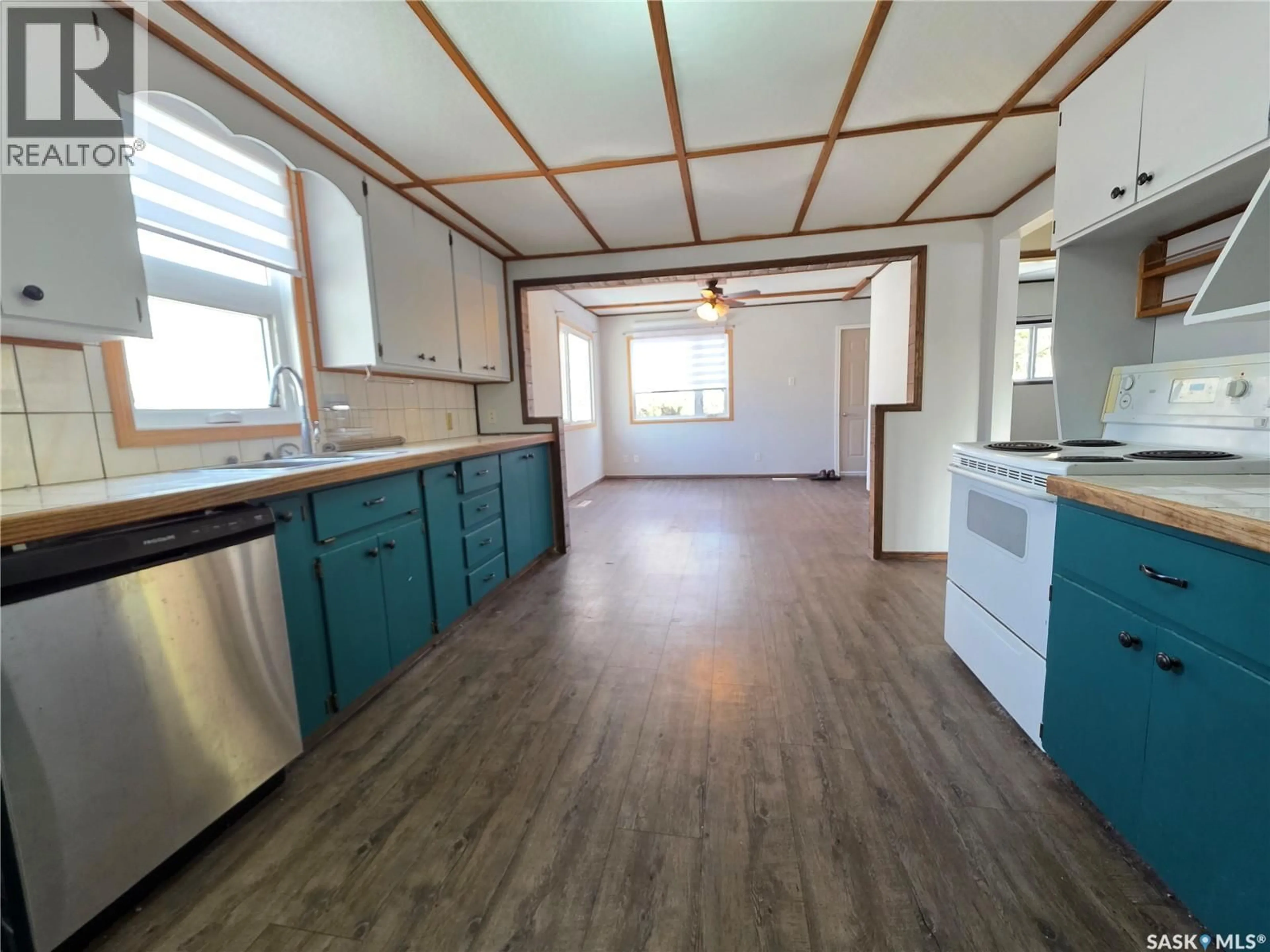 Open concept kitchen, wood/laminate floor for 1428 WINNIE STREET, Swift Current Saskatchewan S9H1R3