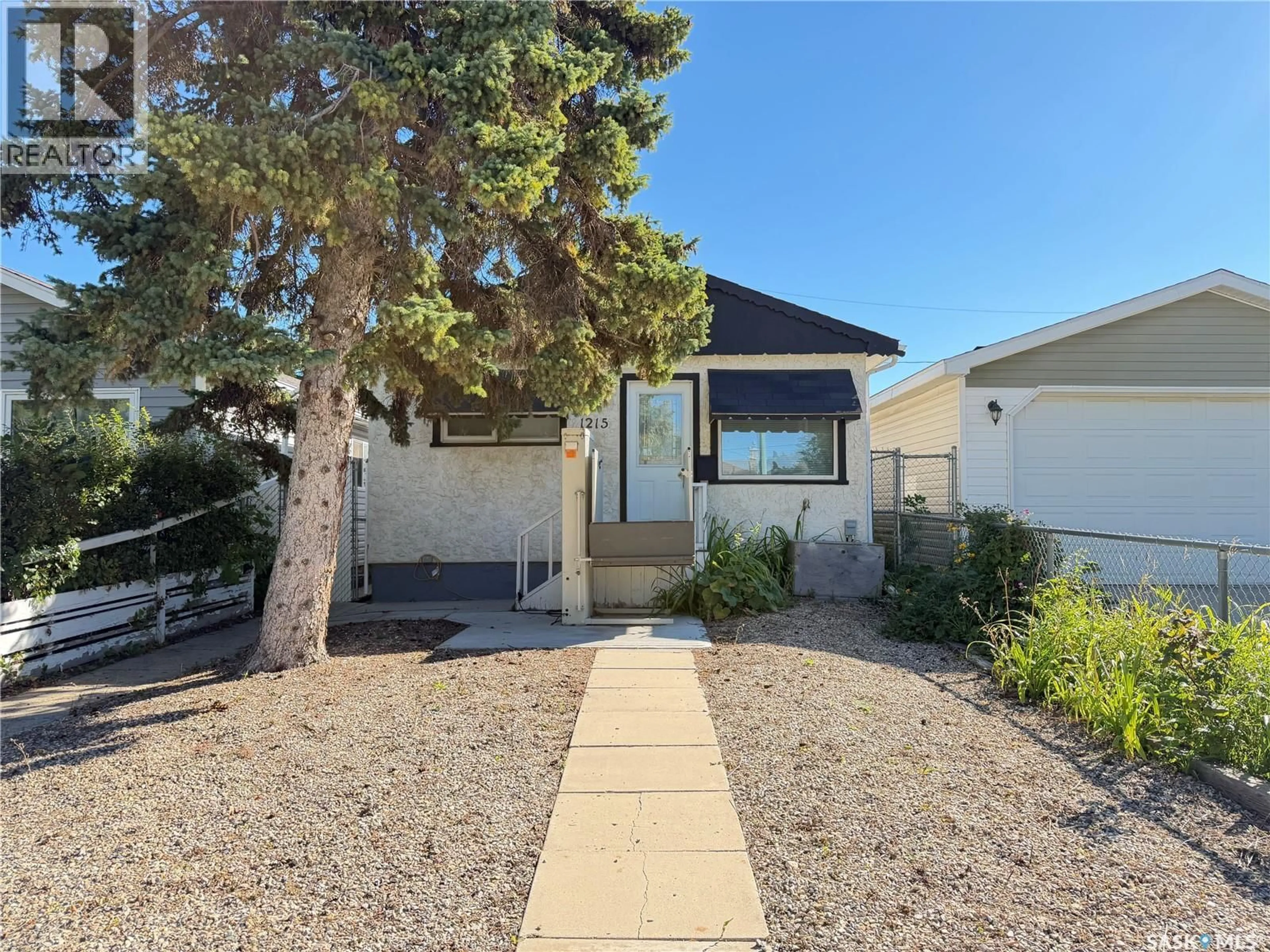 Home with vinyl exterior material, street for 1215 BRODER STREET, Regina Saskatchewan S4N3R3