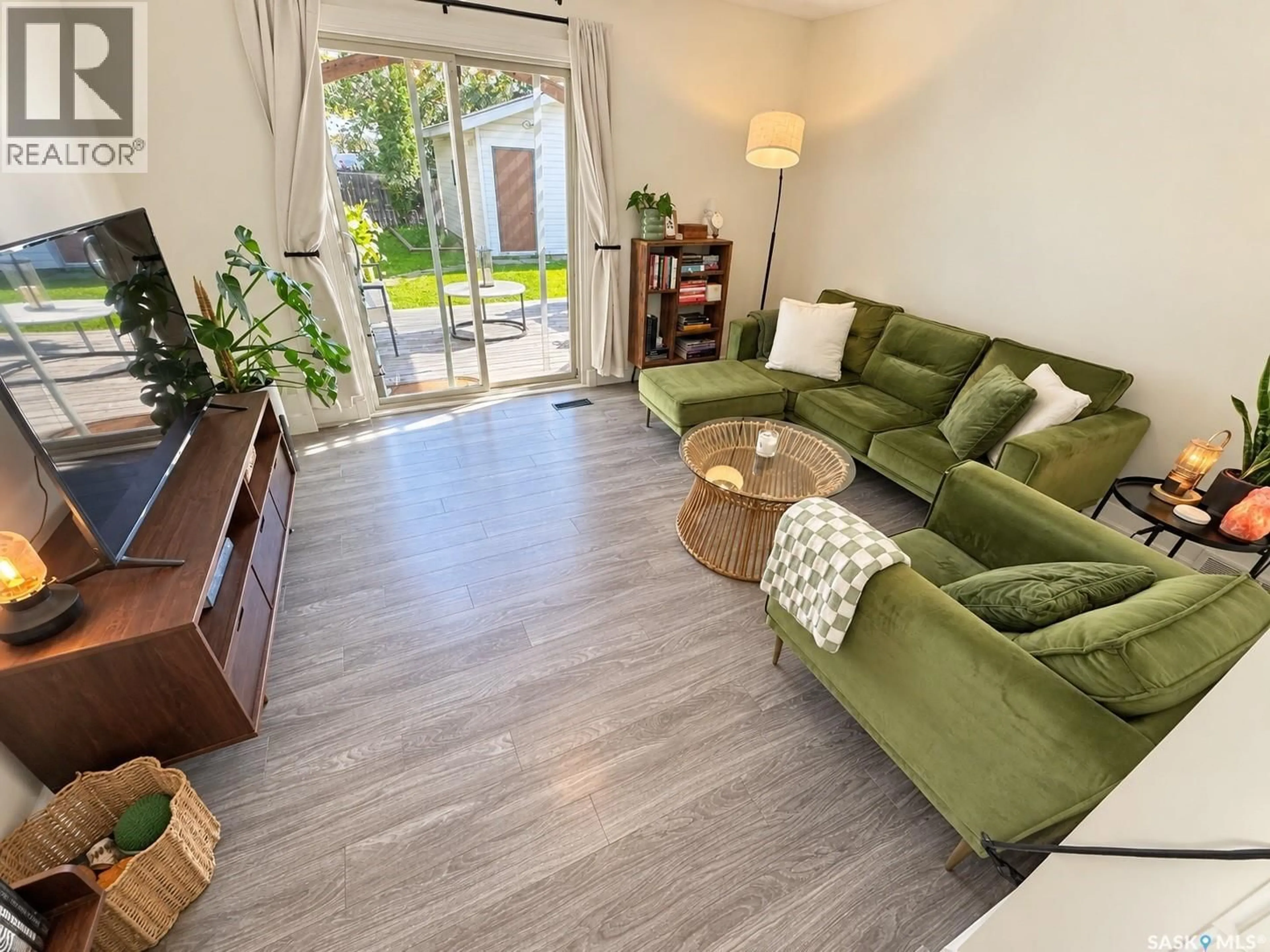 Living room with furniture, wood/laminate floor for 230 10TH STREET, Weyburn Saskatchewan S4H2W3