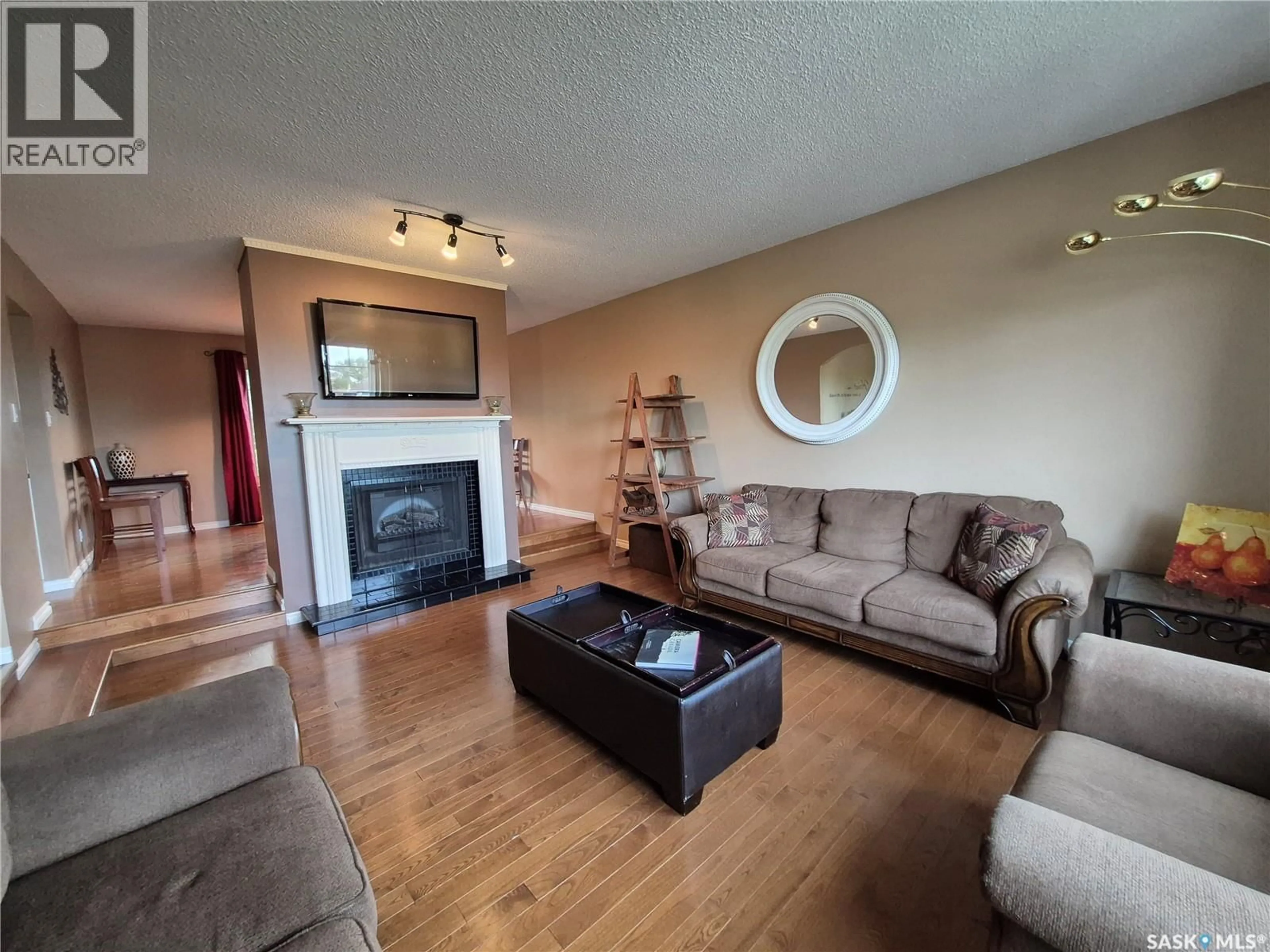 Living room with furniture, wood/laminate floor for 280 HAYES DRIVE, Swift Current Saskatchewan S9H4H1