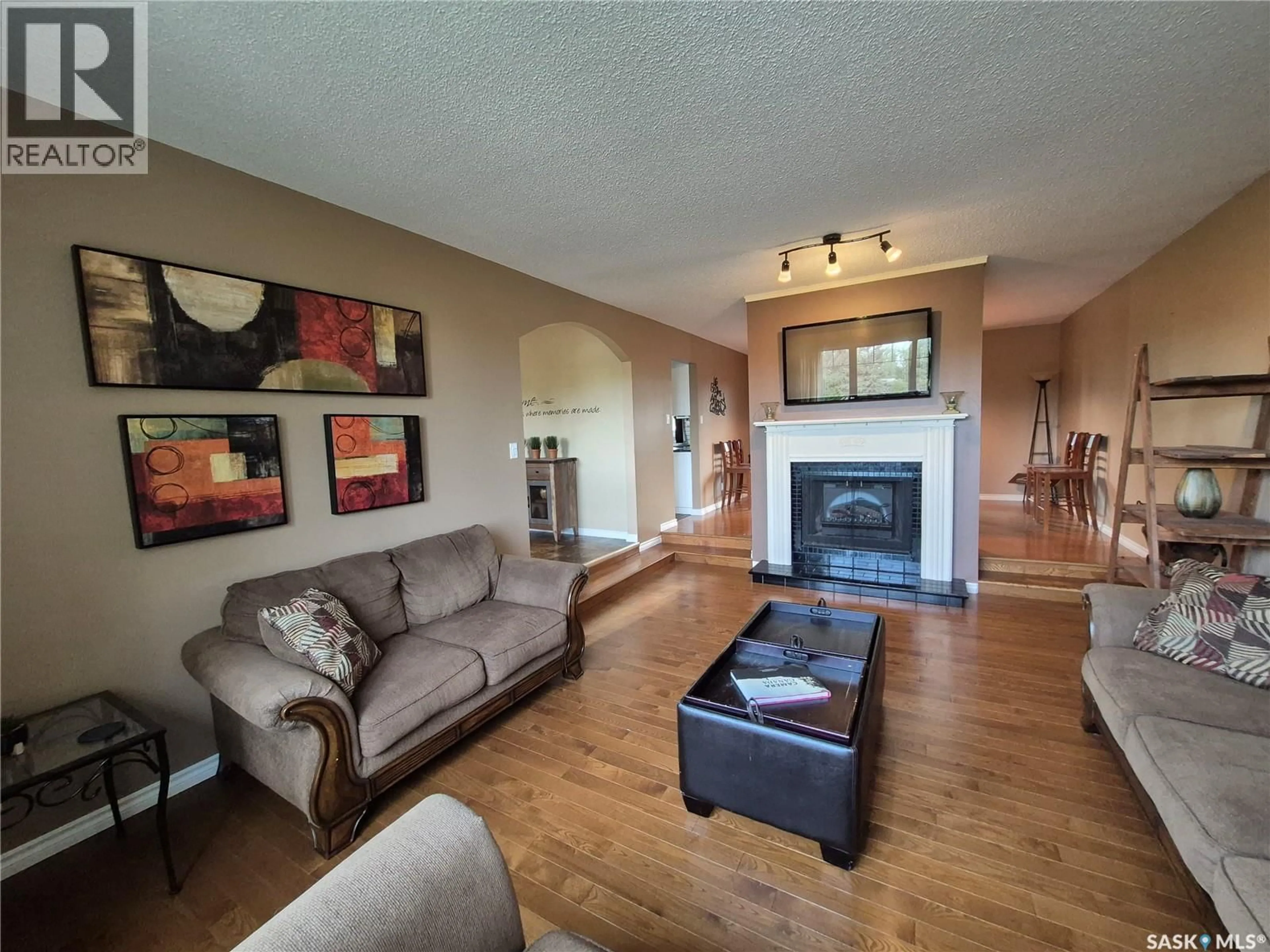 Living room with furniture, wood/laminate floor for 280 HAYES DRIVE, Swift Current Saskatchewan S9H4H1