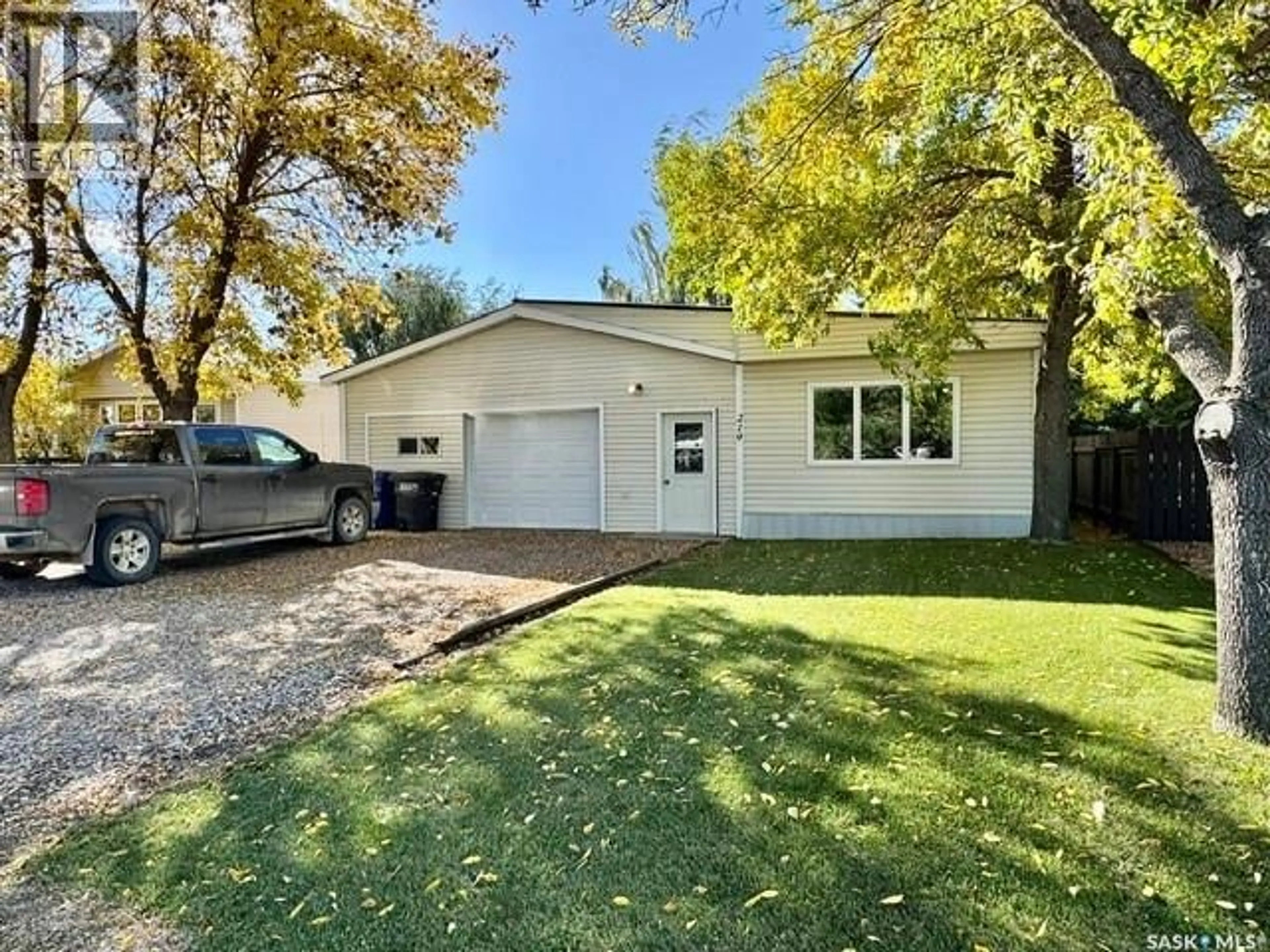 Home with vinyl exterior material, street for 219 13TH STREET, Humboldt Saskatchewan S0K2A0